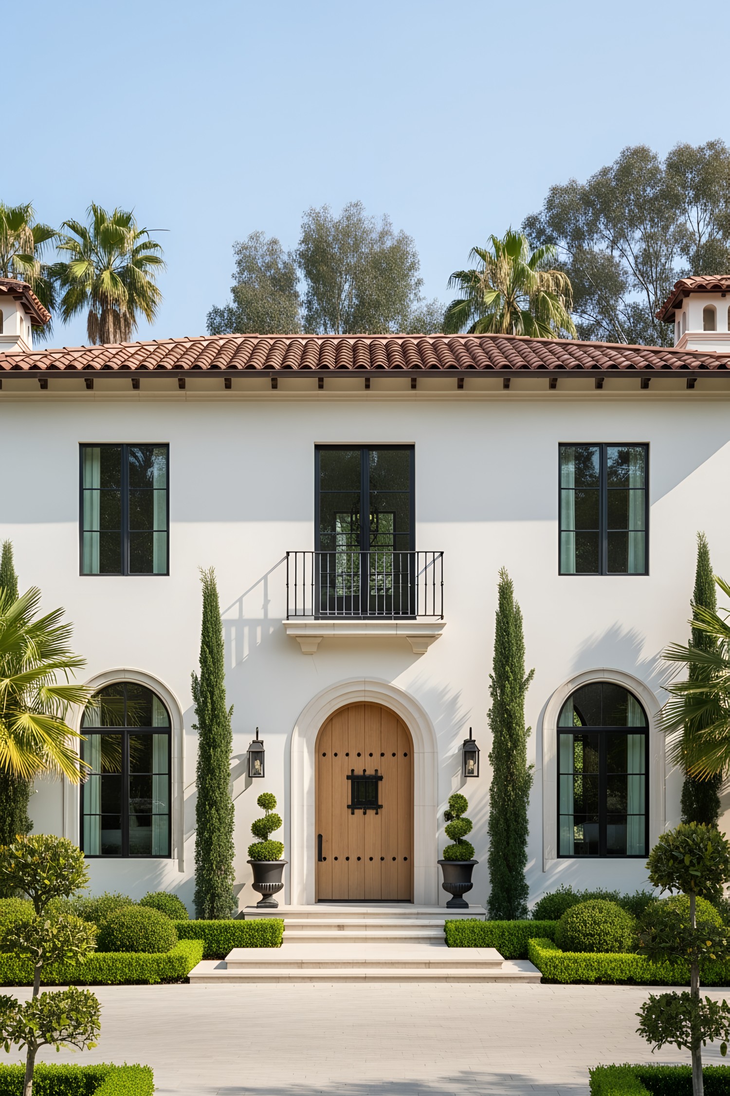 Modern Tuscan villa exterior with lush greenery