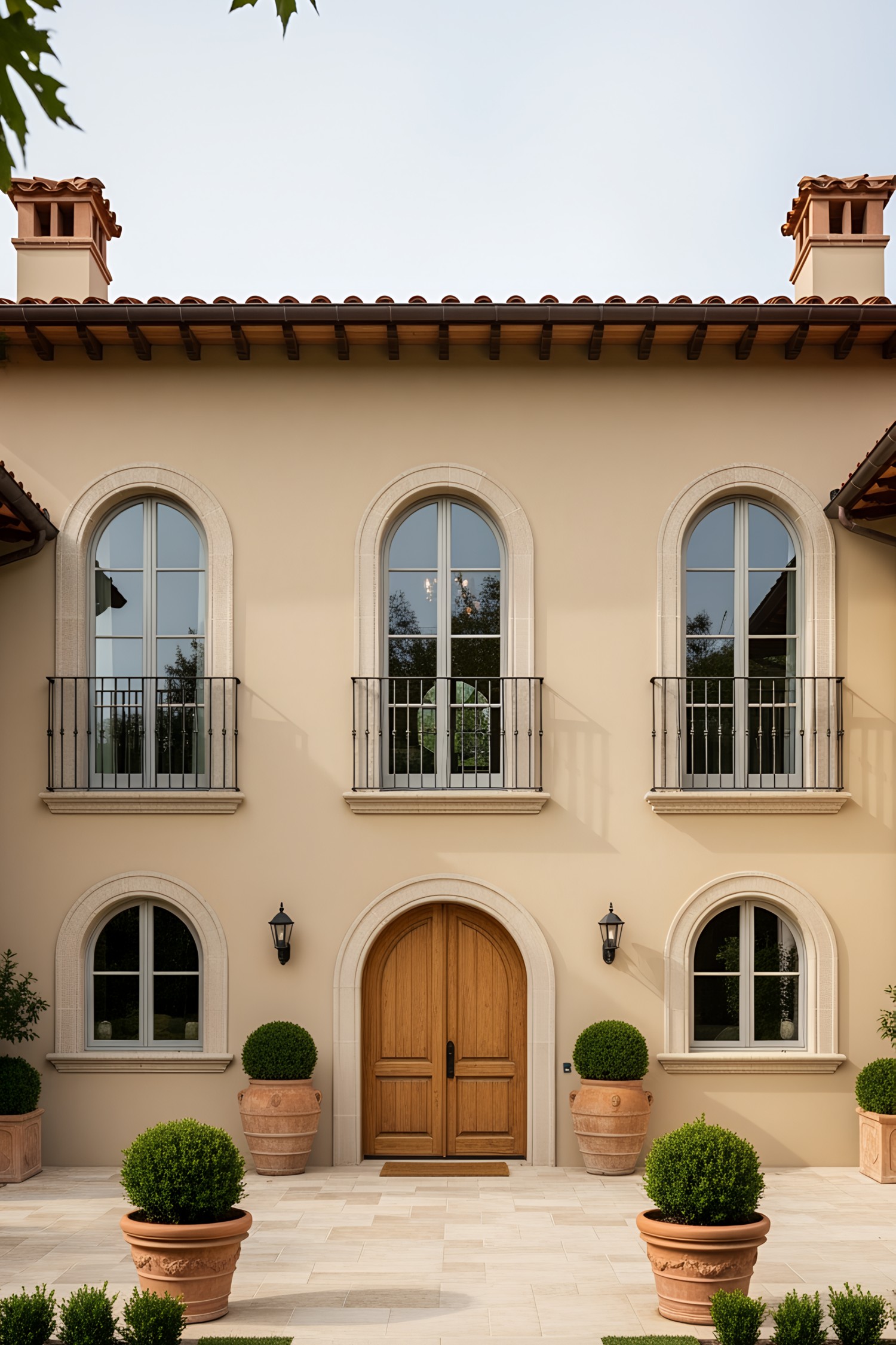 Elegant modern Tuscan villa with arched windows and a wooden door