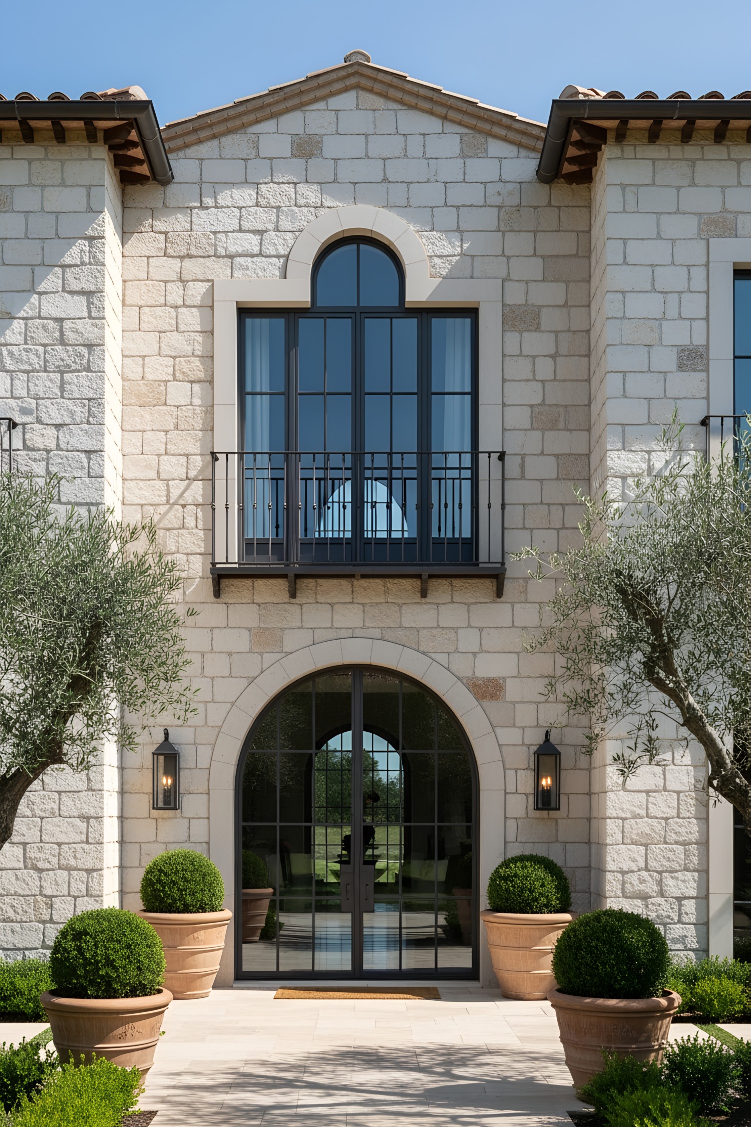 Modern Tuscan villa with stone exterior and arched windows
