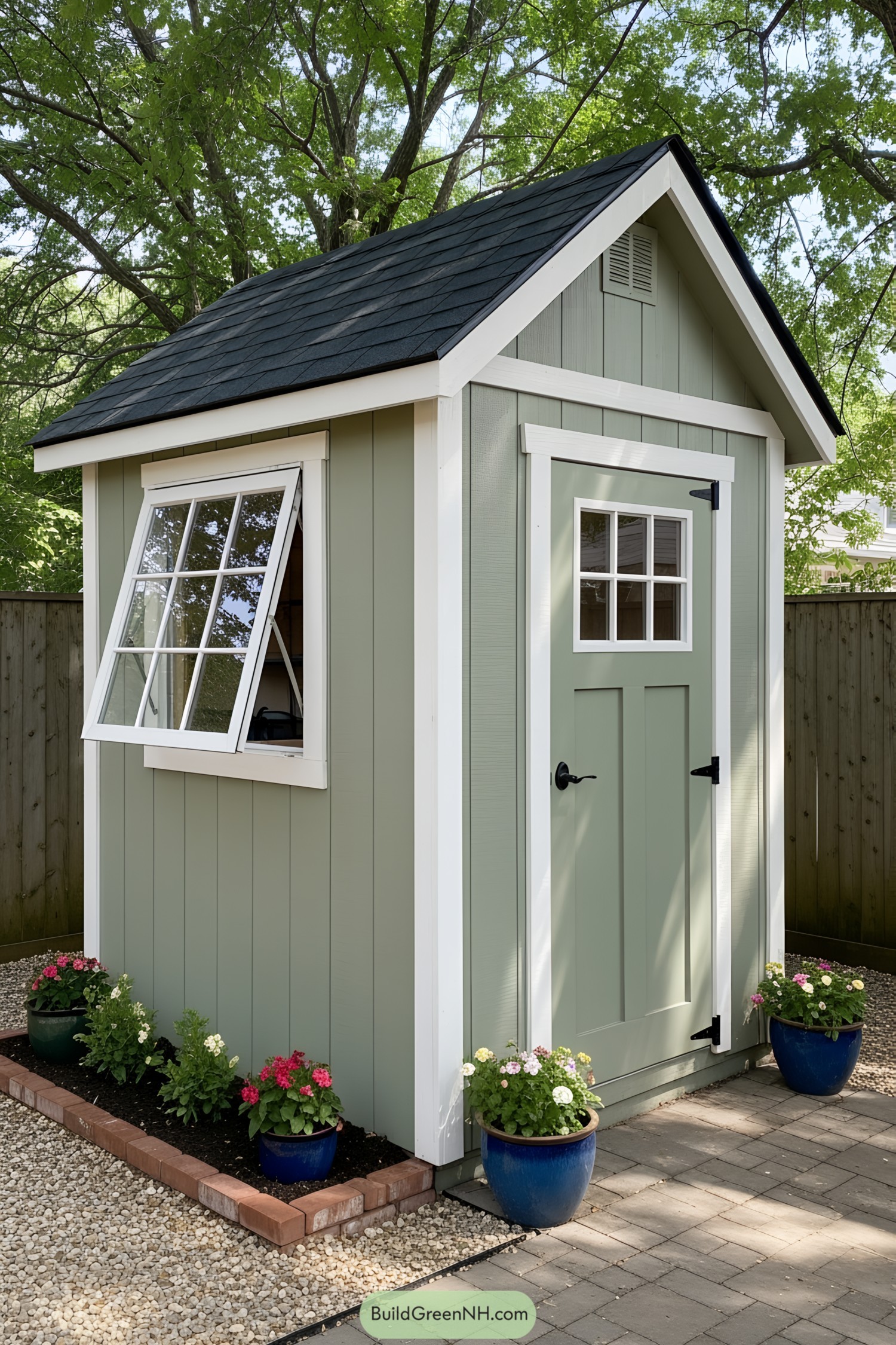 Small shed with green siding and potted plants