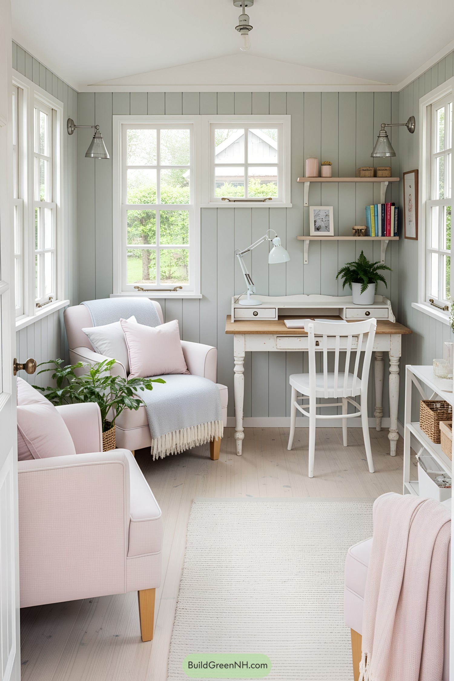 Bright, pastel she shed with cozy seating and a rustic desk