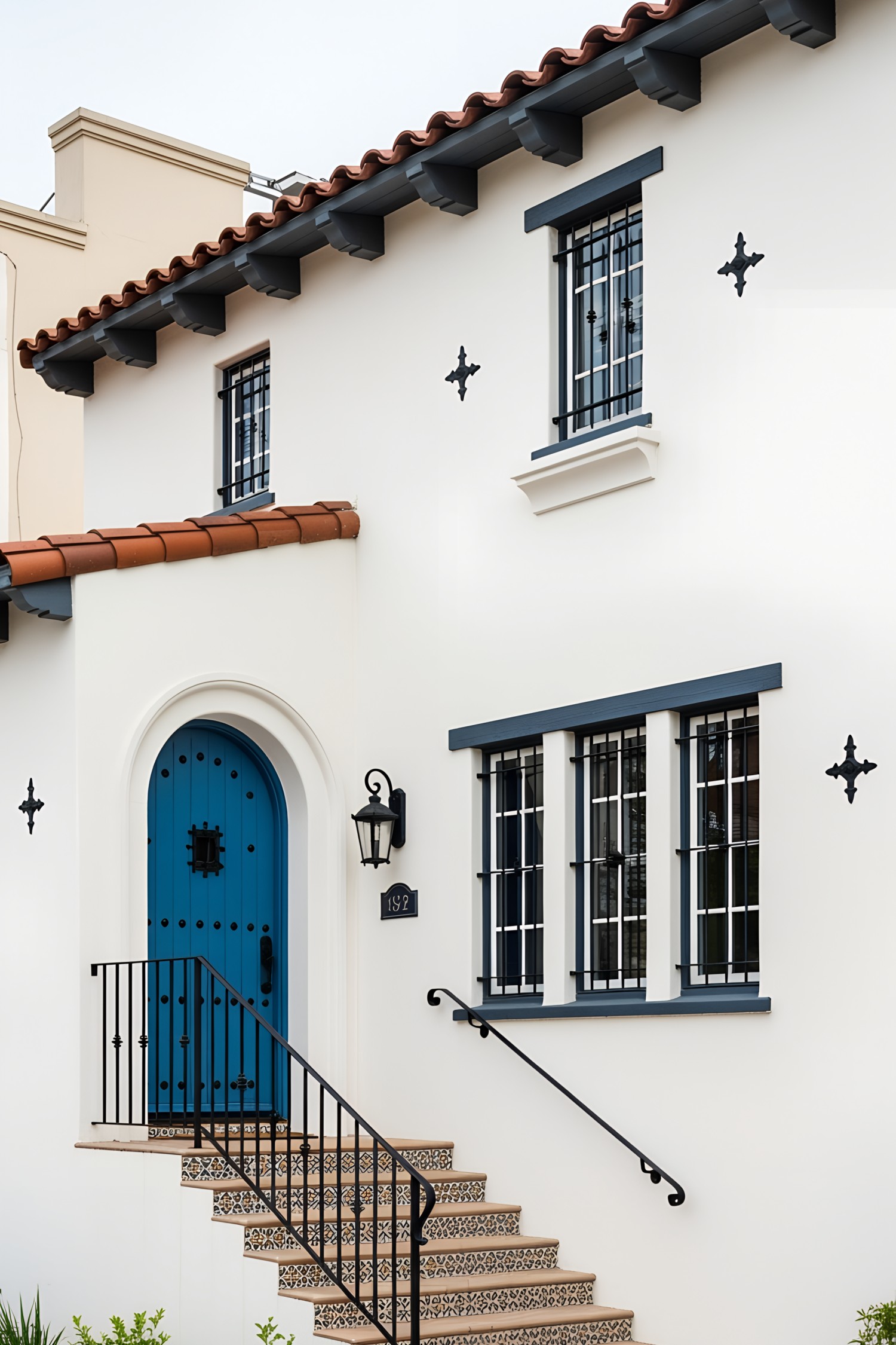 White house facade with a vibrant blue door