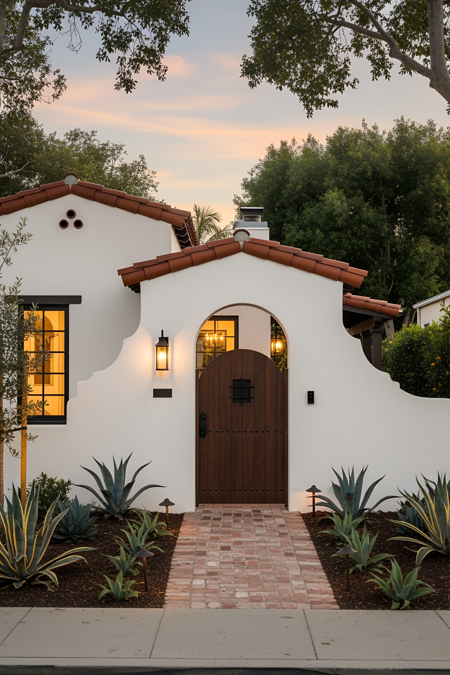 Spanish coastal house exterior with arch and plants