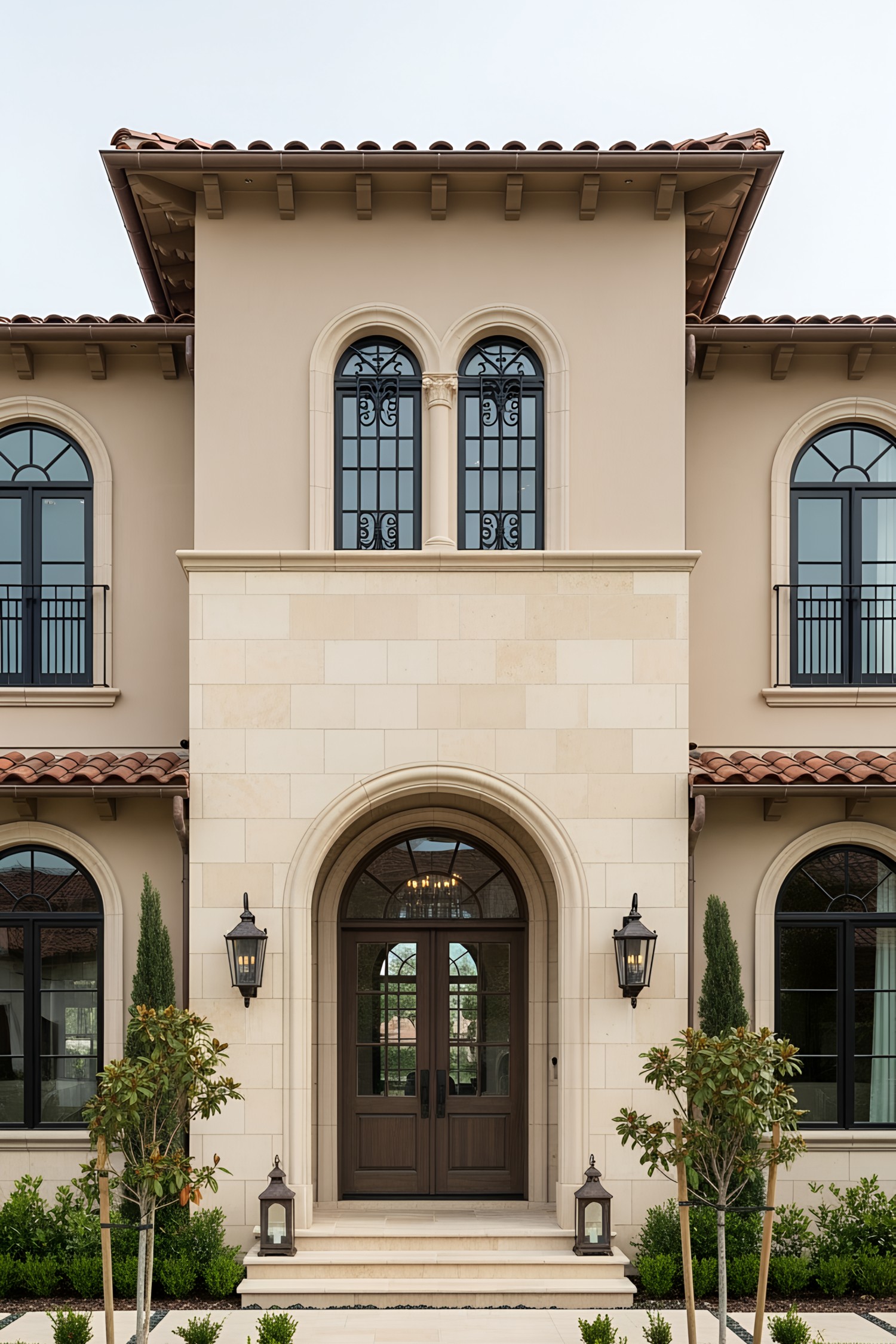 Elegant coastal house entrance with arched windows