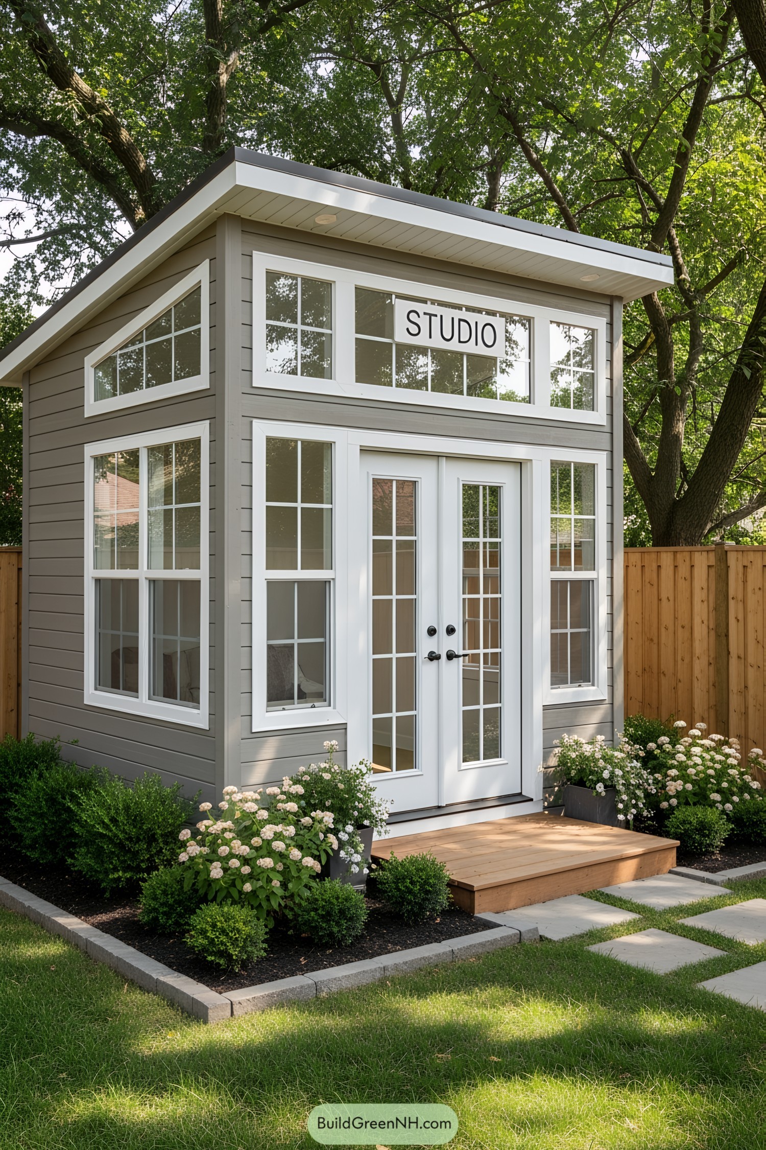 Cute studio shed with lots of windows and greenery