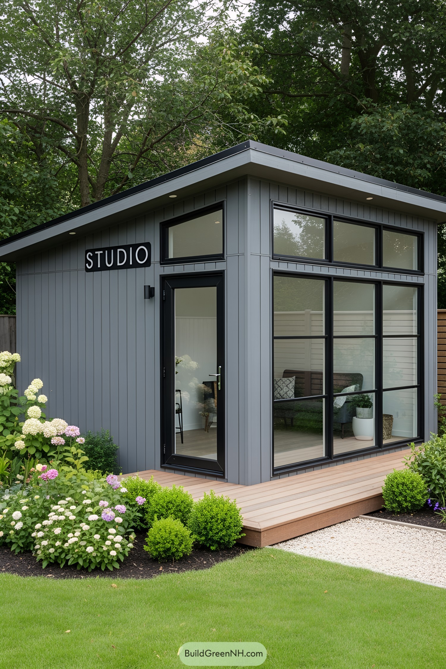 Compact gray studio shed with large windows