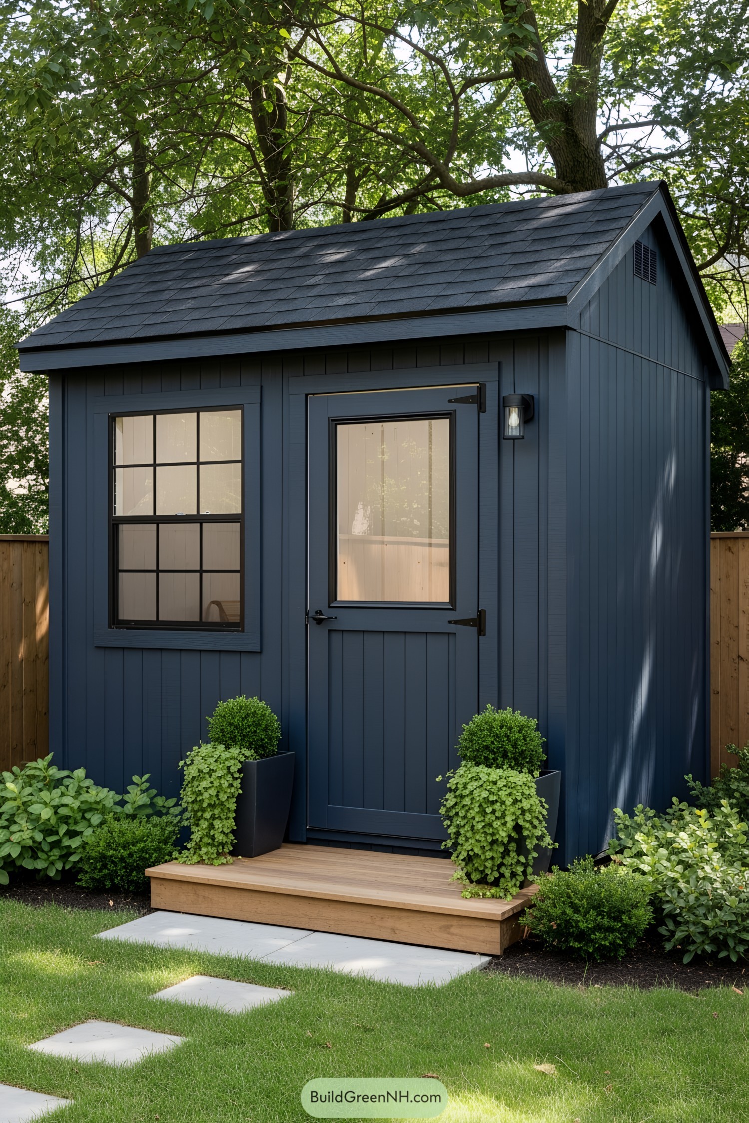 Small blue shed surrounded by greenery