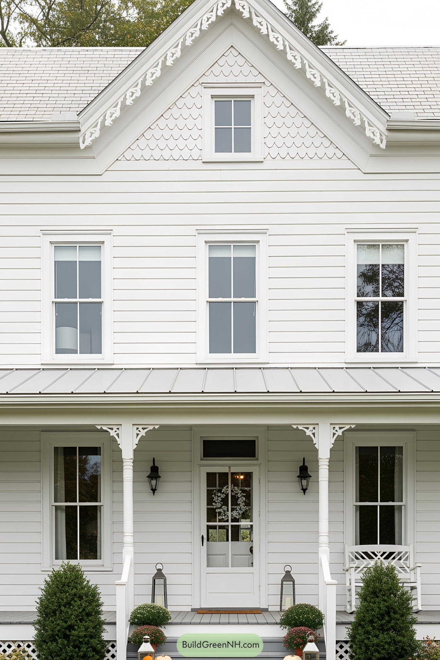 Large Victorian farmhouse with white siding and intricate decorative trim