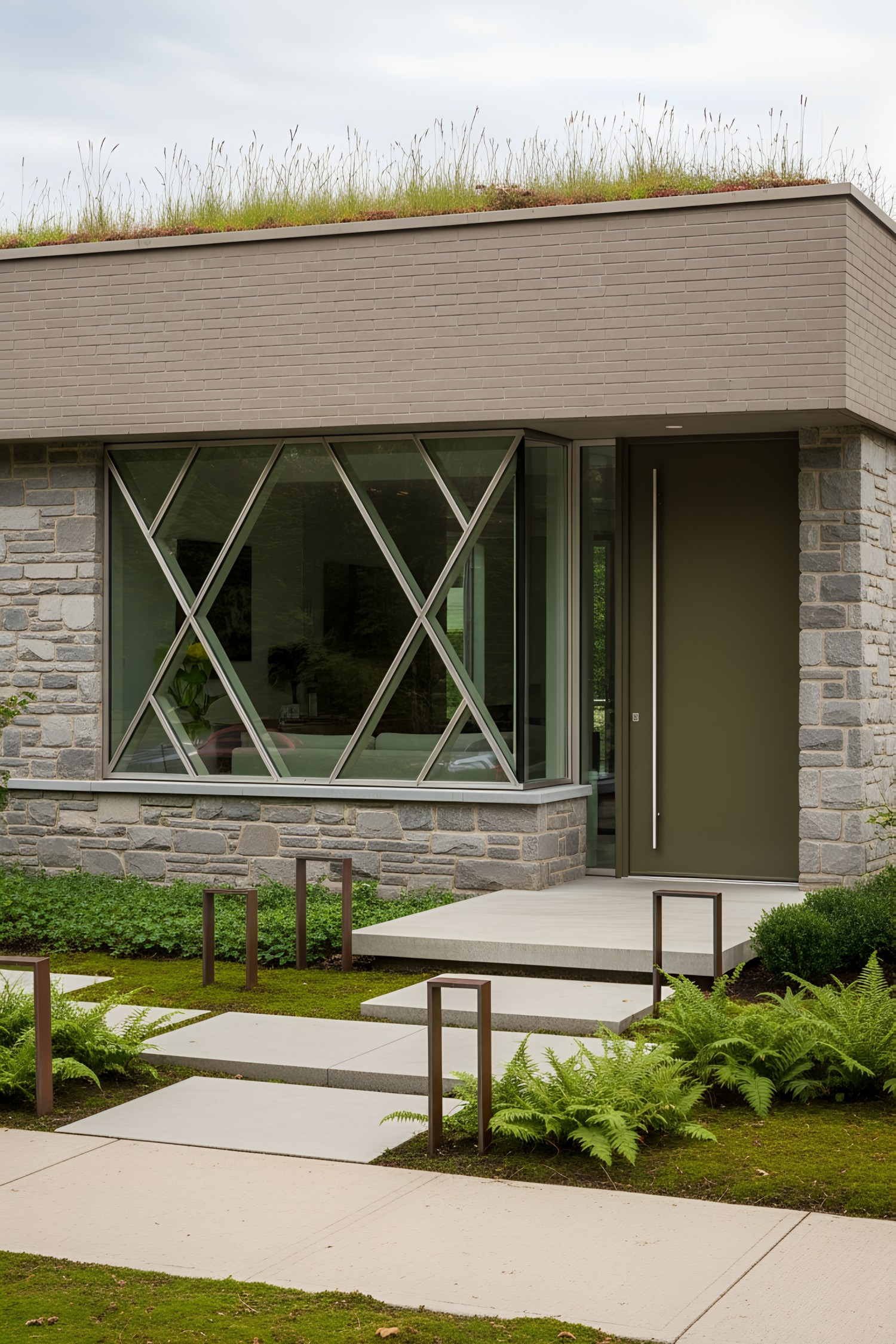 House with unique geometric windows and grassy roof