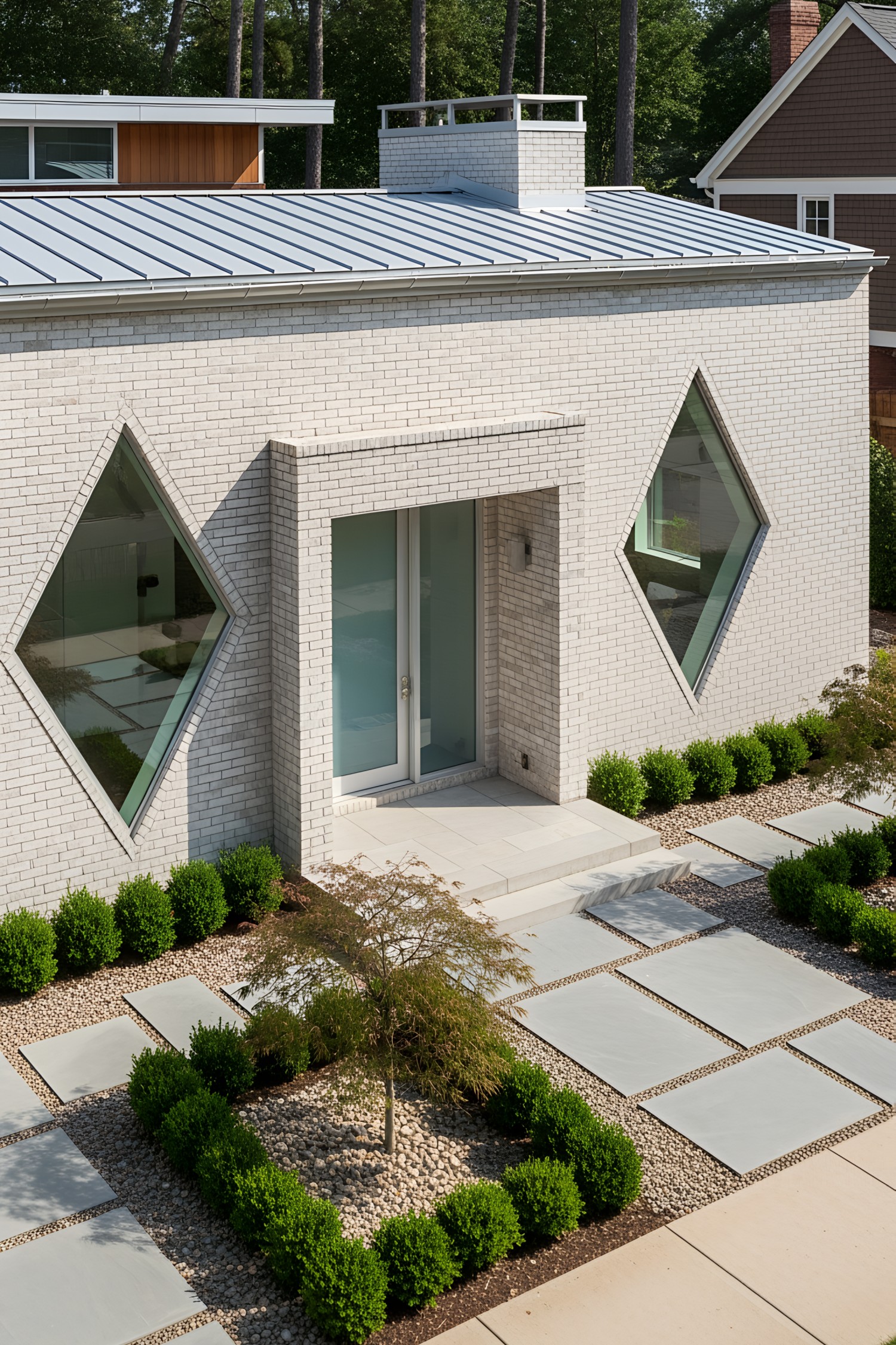 Brick house with diamond-shaped windows and modern landscaping