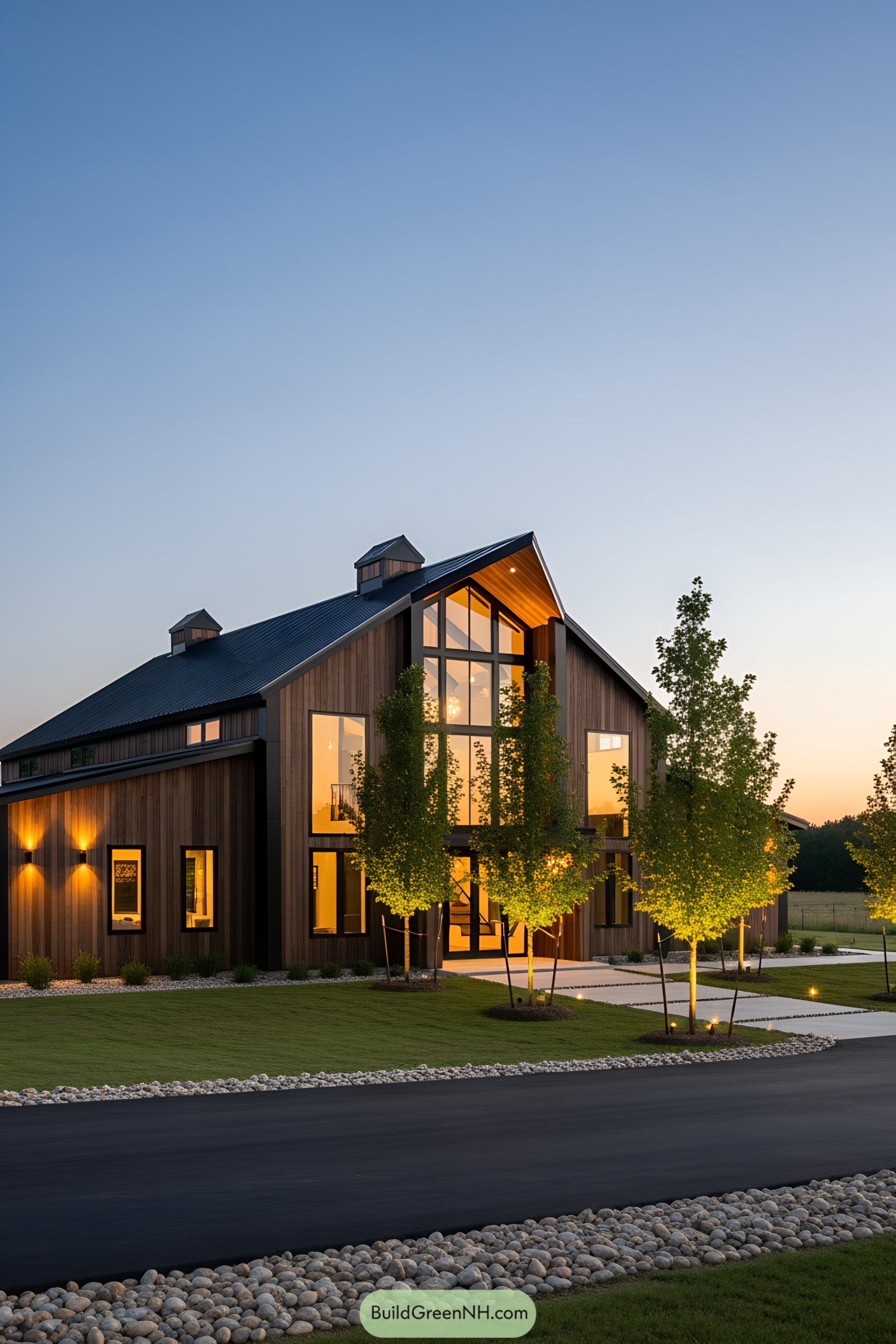 A modern barndominium glowing with LED lights at dusk