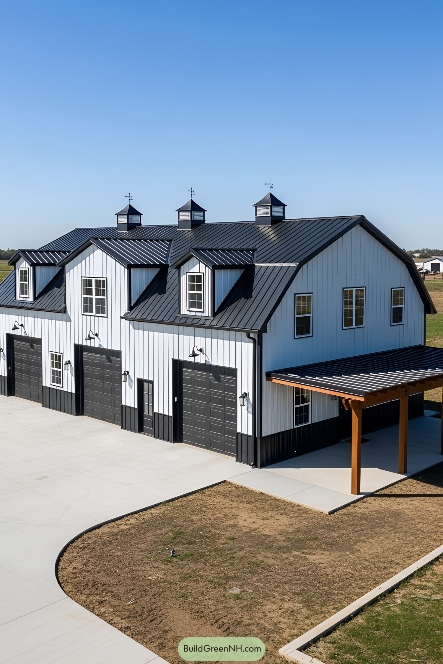 Sleek black and white barndominium with cupolas