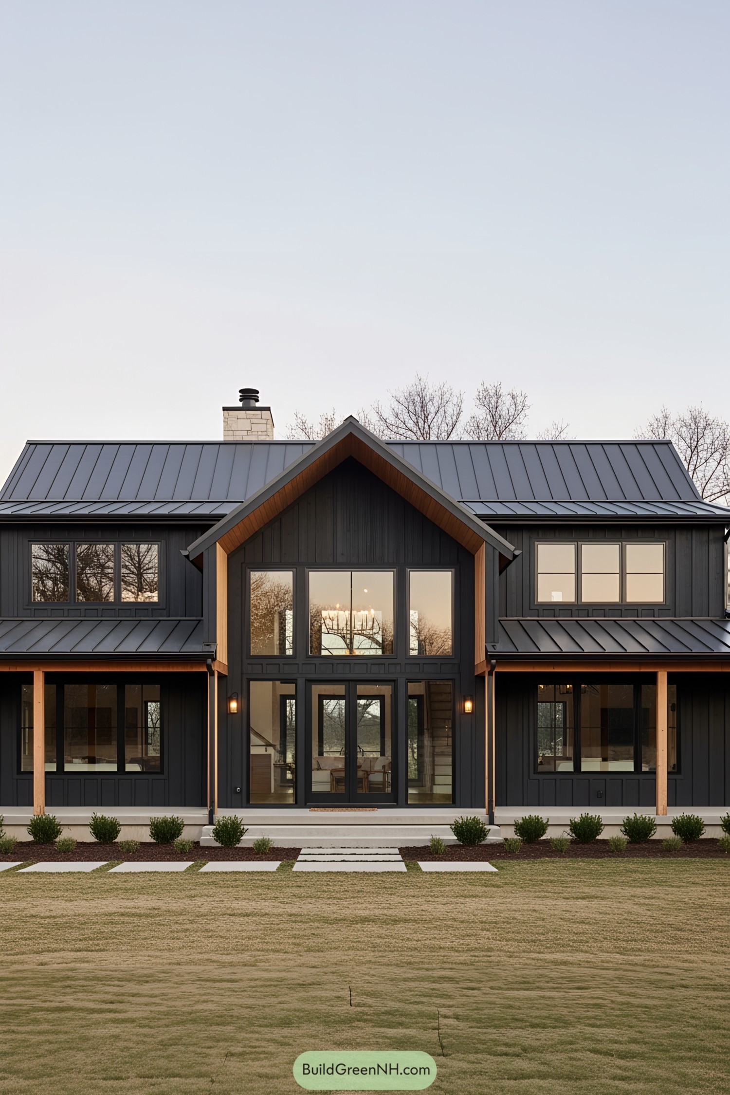Two-story modern ranch house with tall windows and dark siding