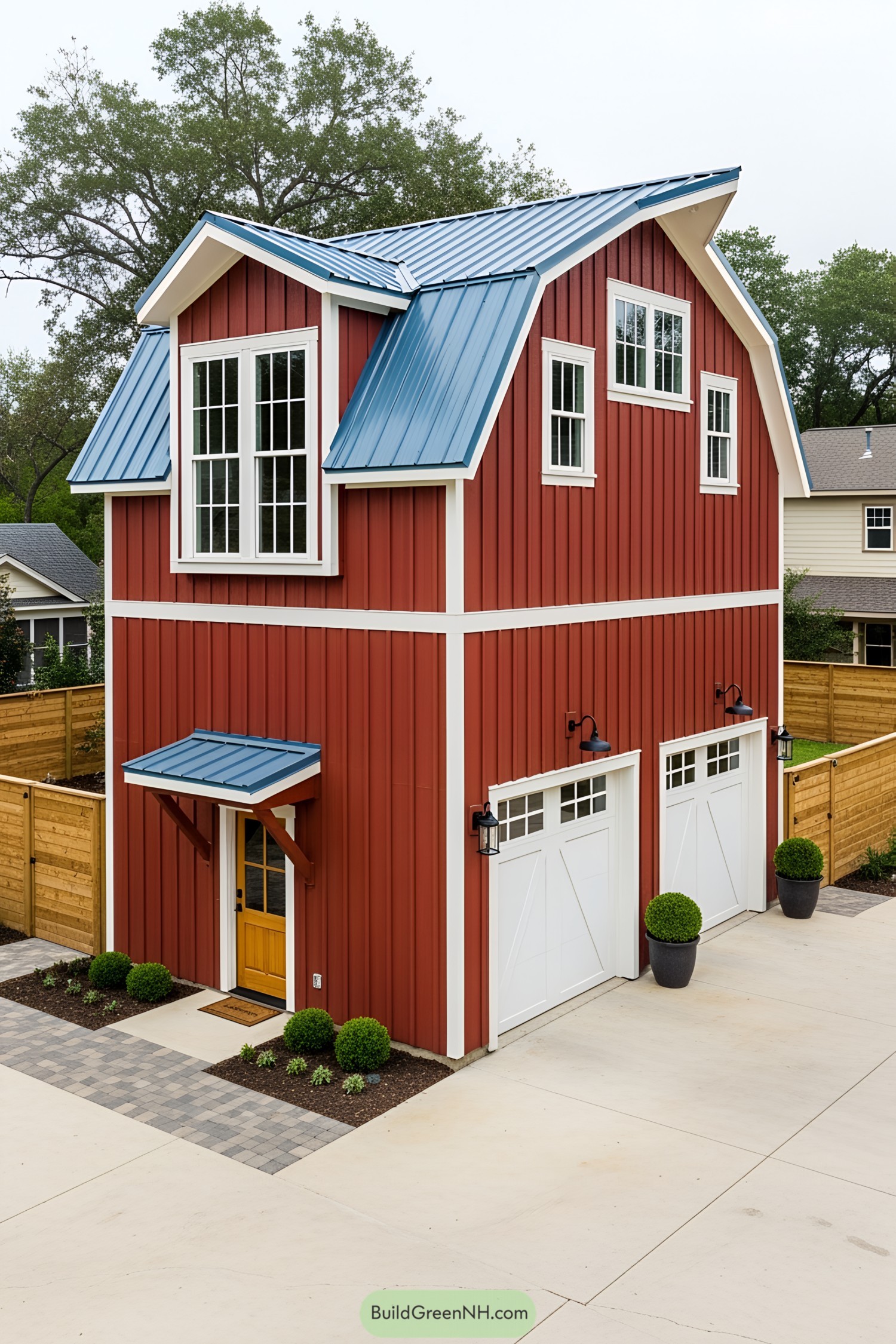 Red barn-style house with a blue roof and garage