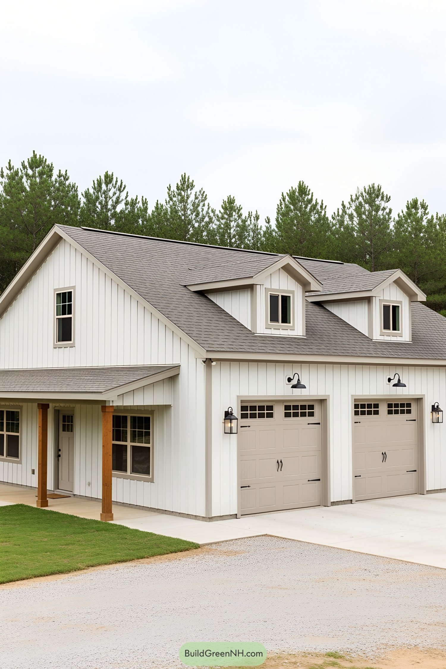 White barndominium with two garages and dormer windows