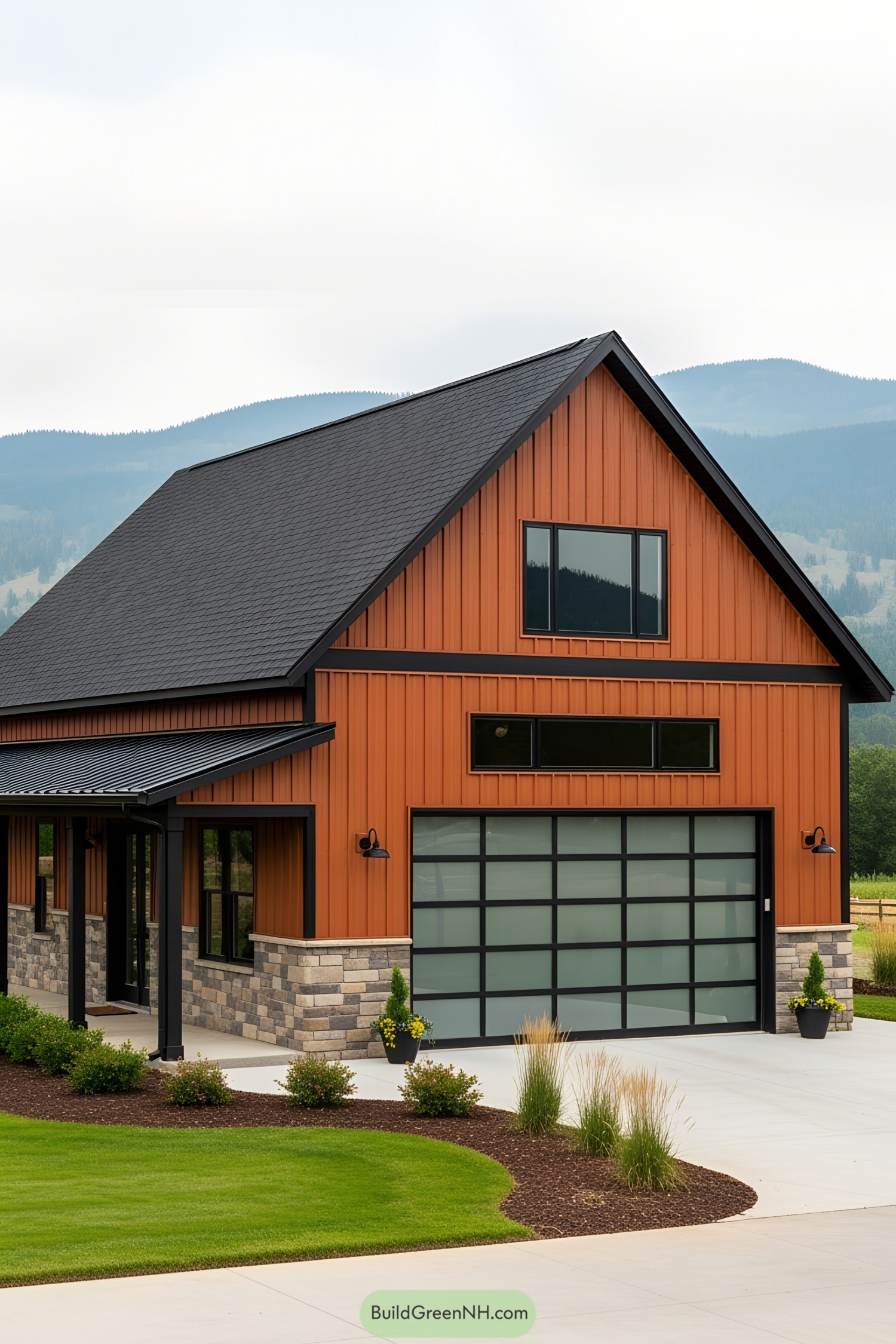 Orange barndominium with sleek garage and mountain backdrop
