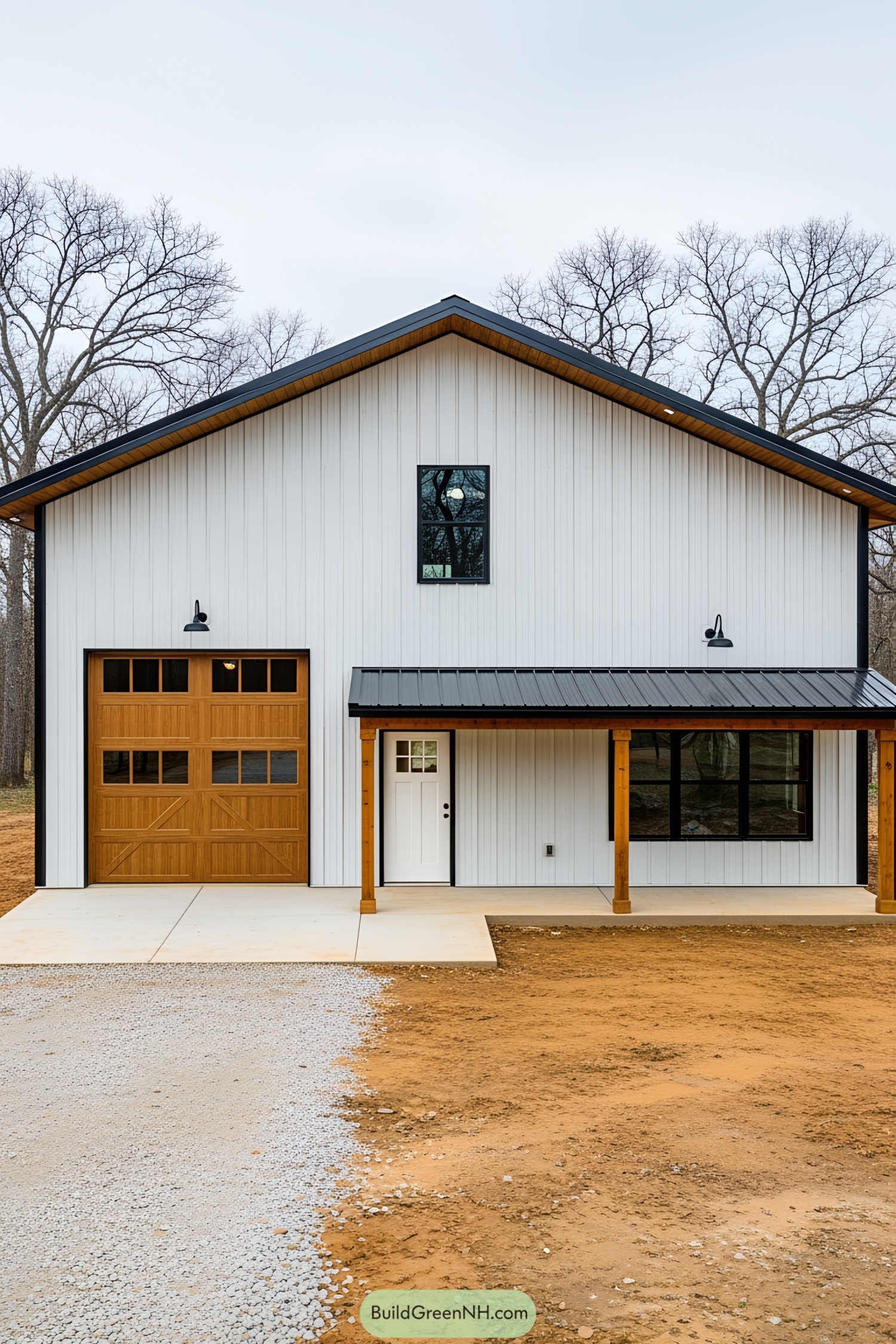 White barndominium with a wooden garage door