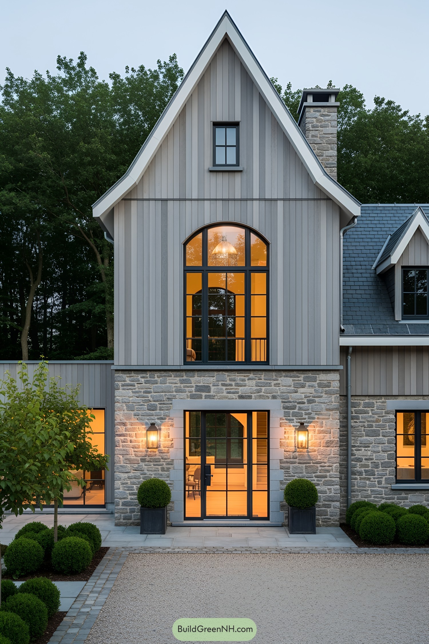 Elegant farmhouse with large windows and stone facade