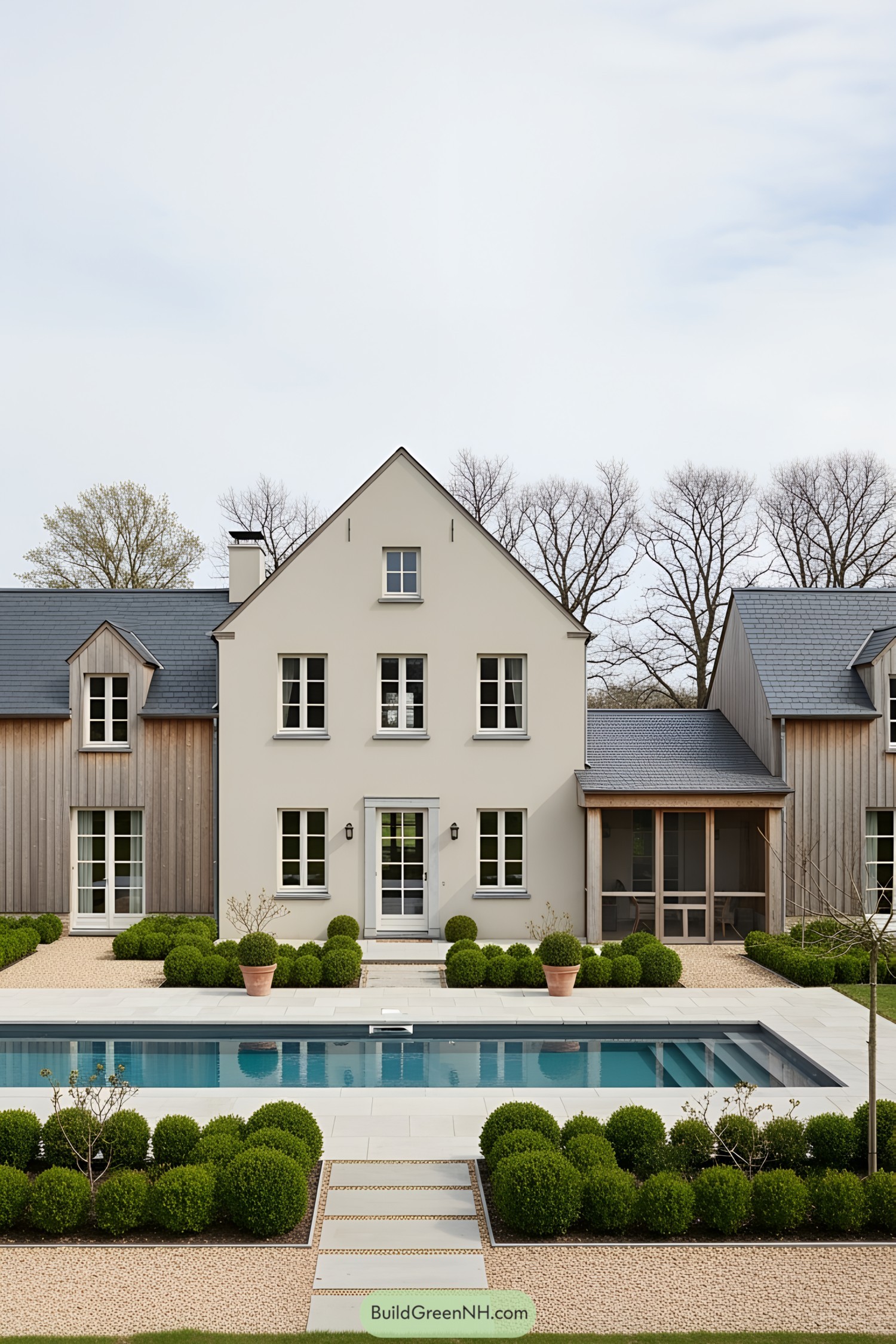 Stylish farmhouse with a sleek pool and lush greenery