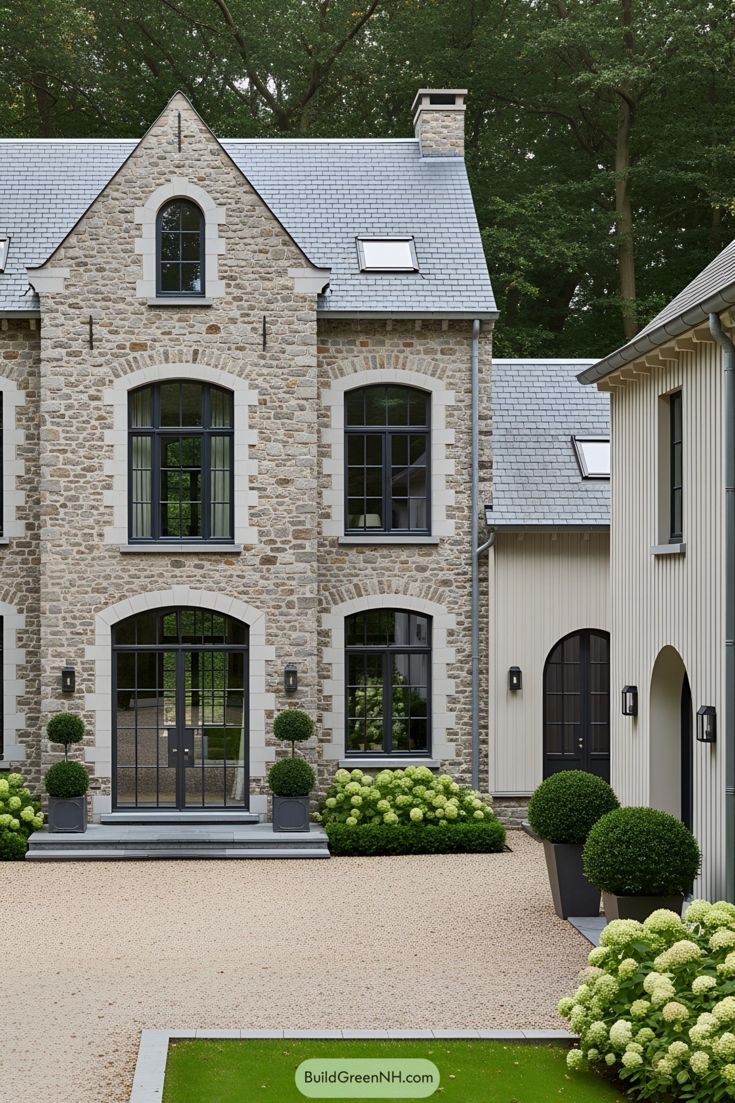 Elegant stone farmhouse facade in a lush green setting