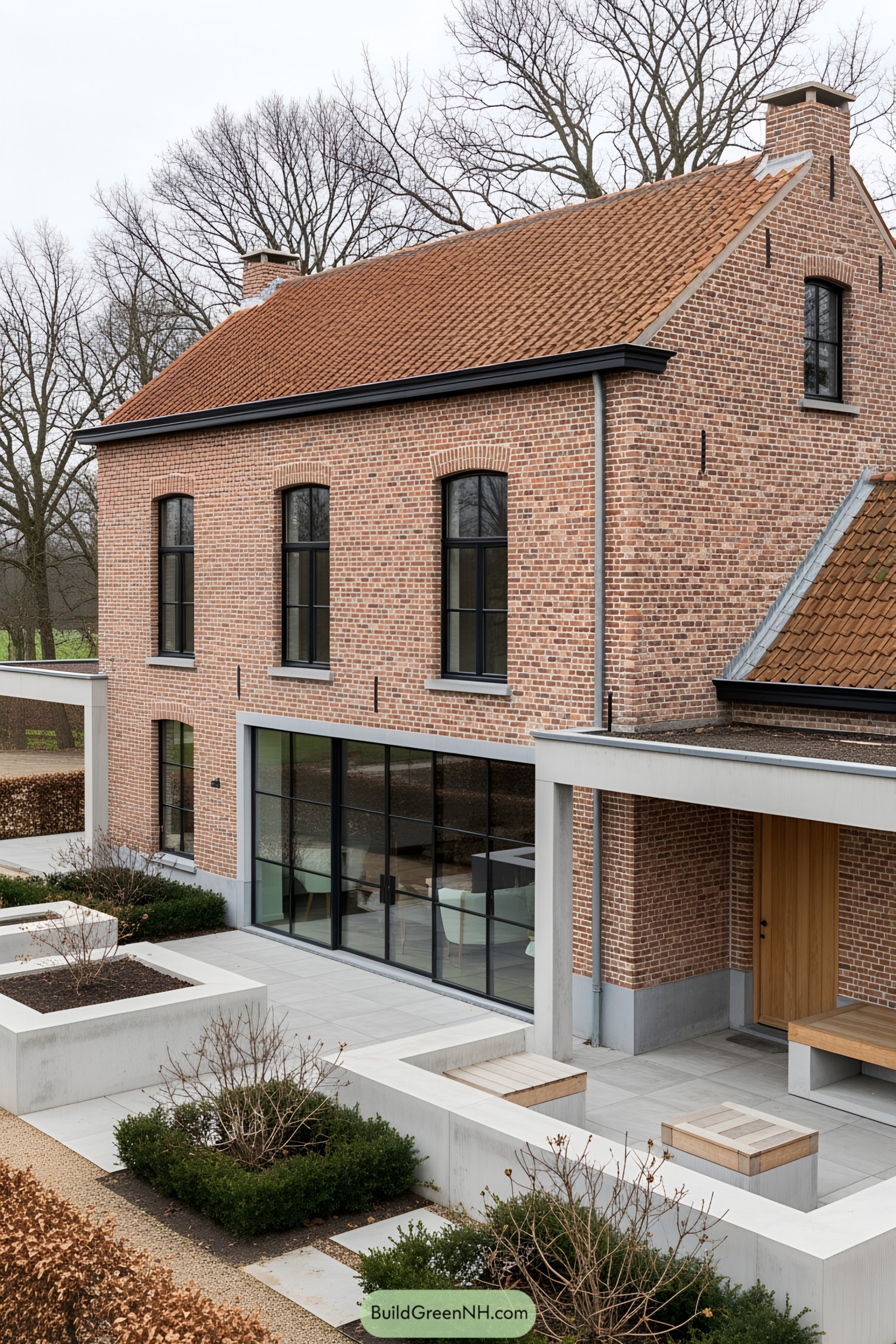 Belgian farmhouse with brick facade and large glass windows