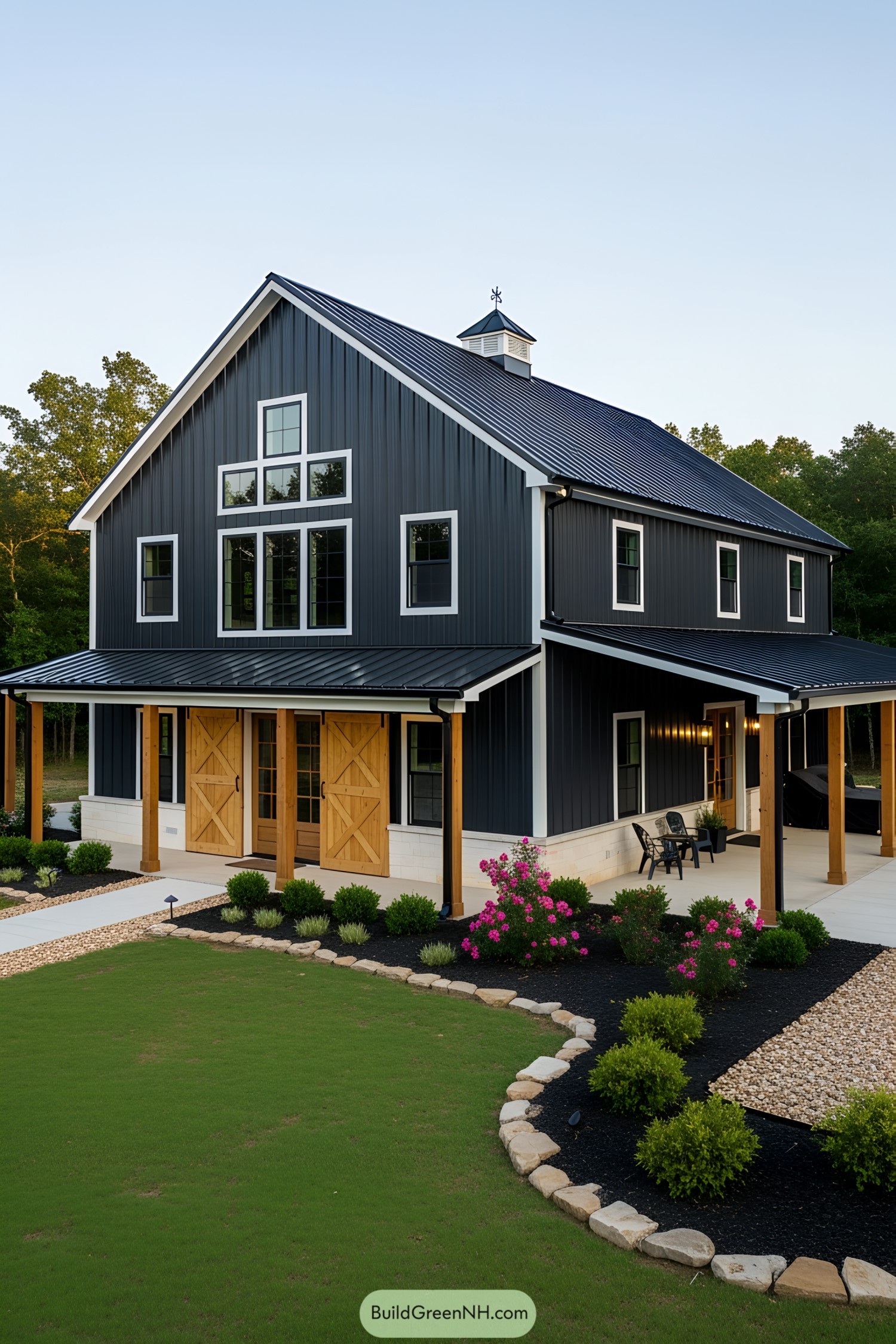 Black and white barndominium with wooden accents and lush lawn