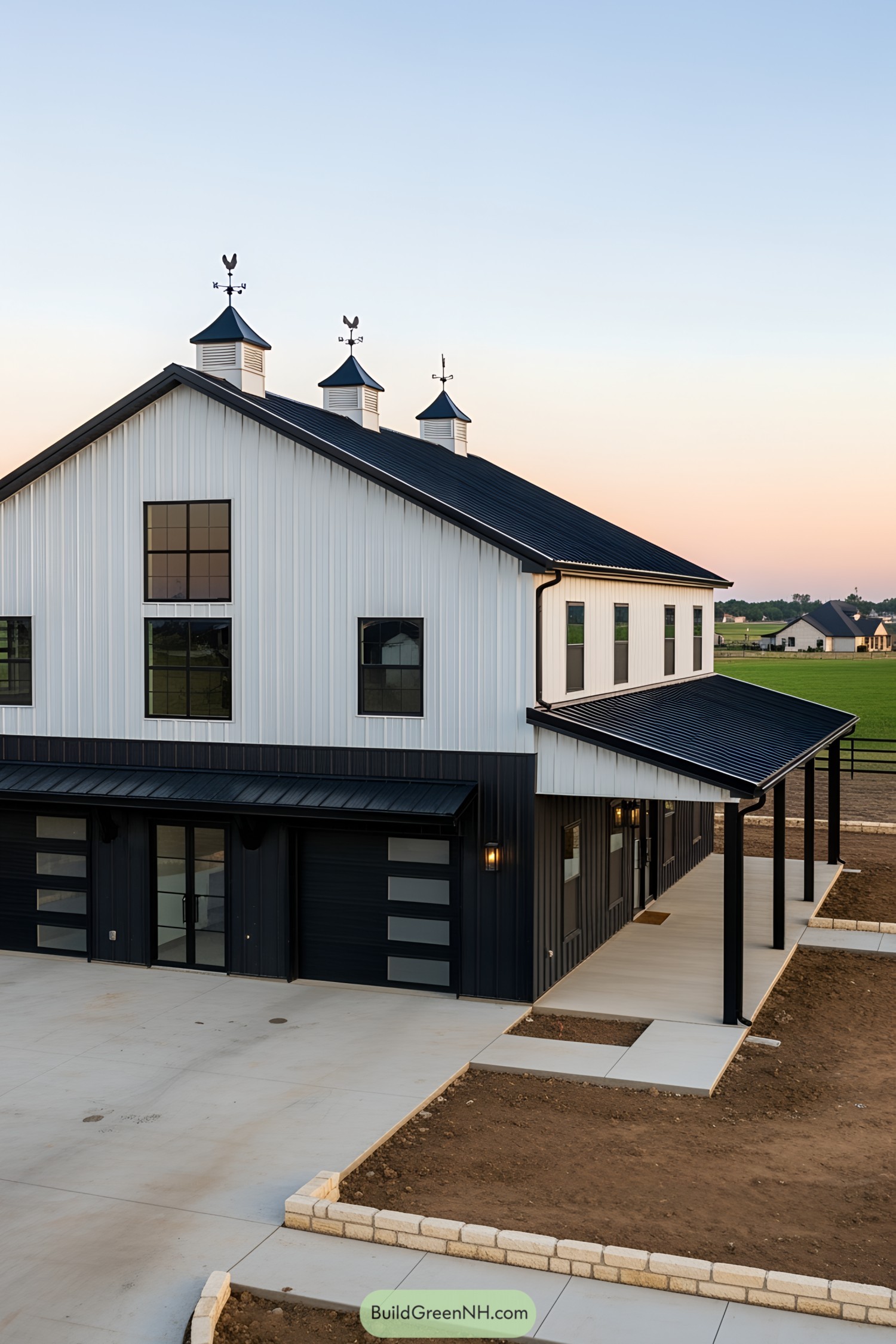 Black and white barndominium with cupolas and large windows