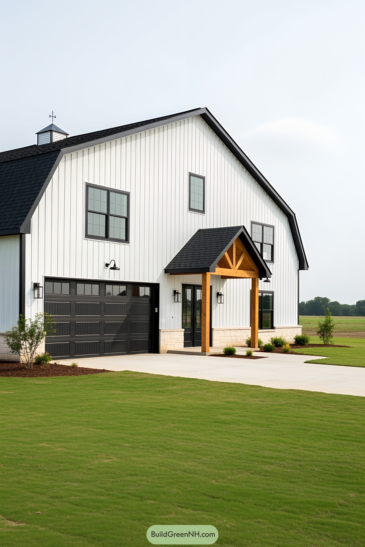 Black and white barndominium with a sloped roof