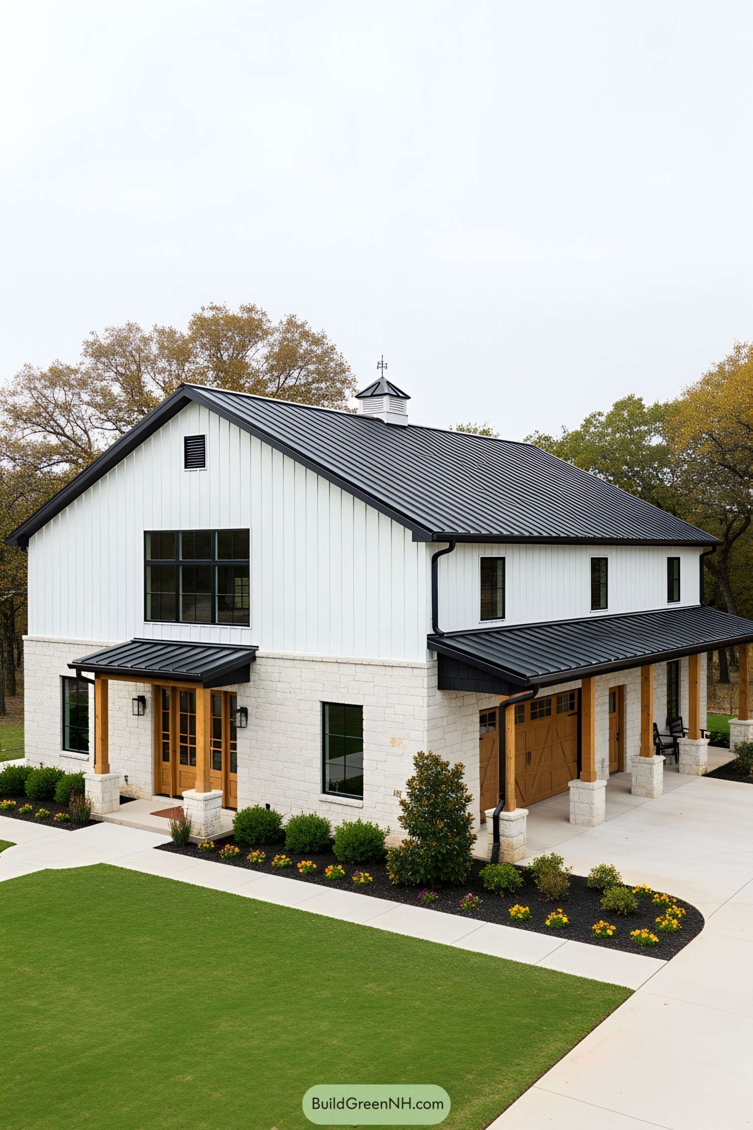 Modern barndominium with black roof and white walls