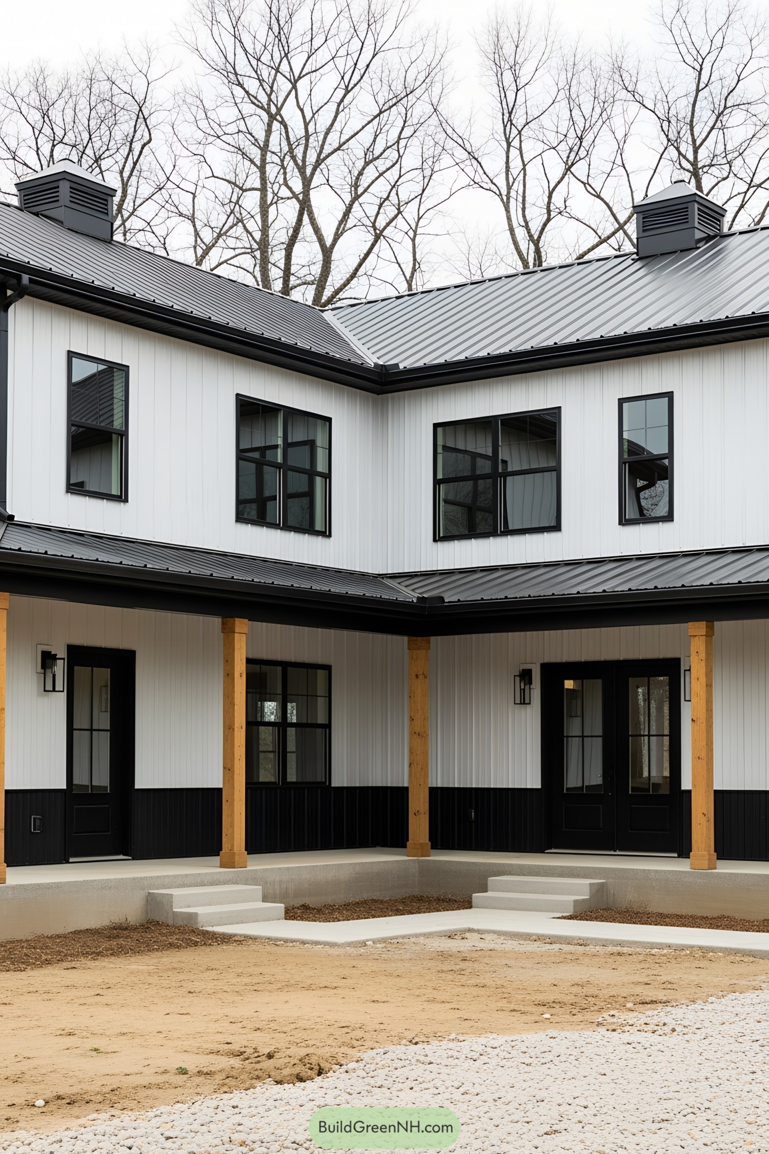 Modern black and white barndominium with wooden pillars