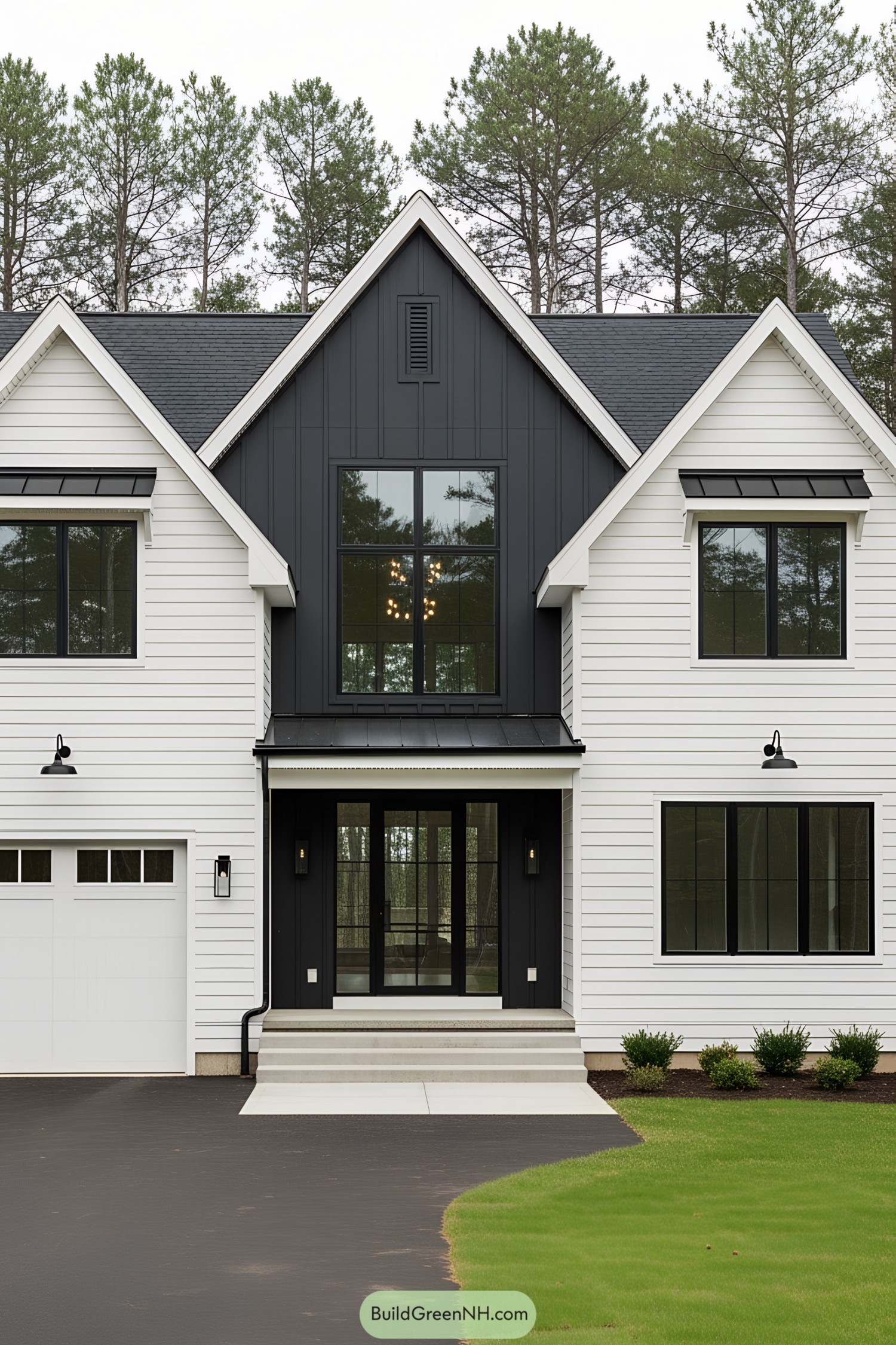 Black and white farmhouse with large windows and lush front yard