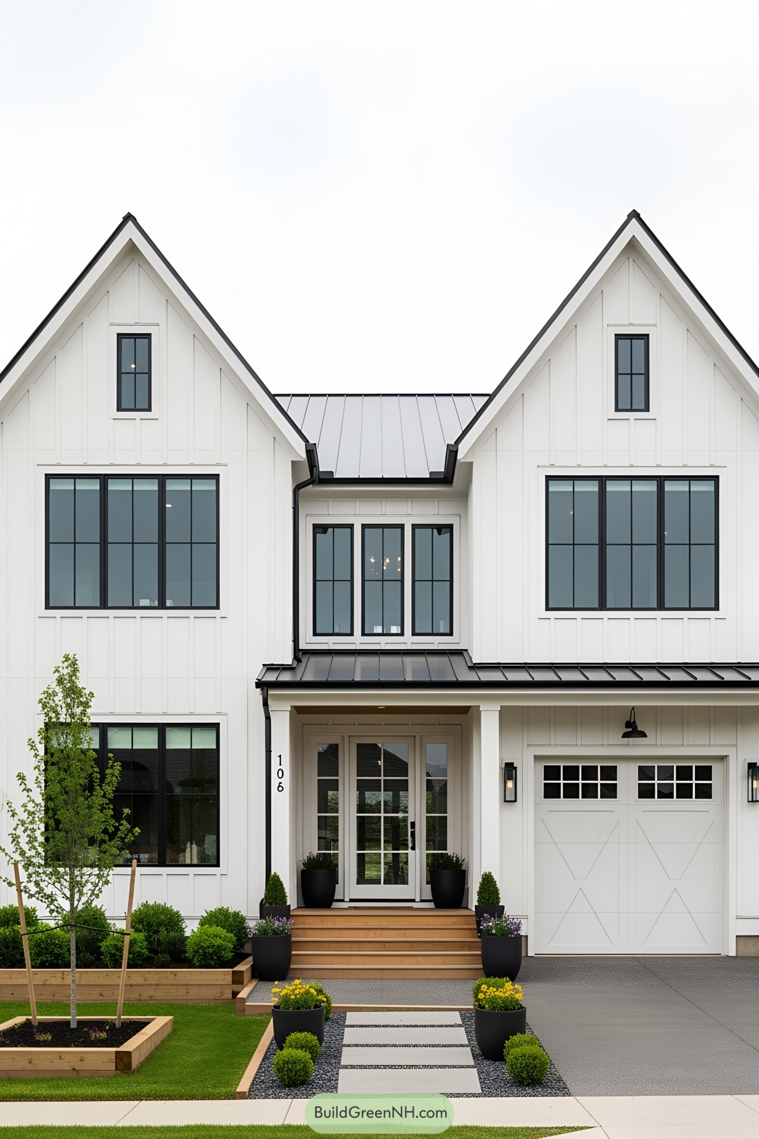 Black and white farmhouse with sleek design and lush landscaping