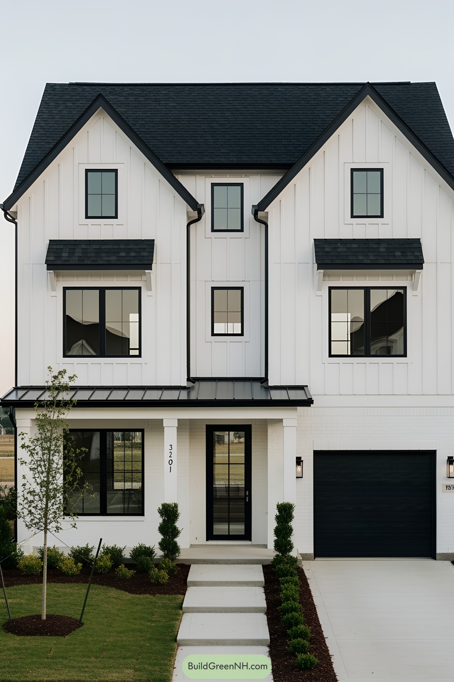 Modern black and white farmhouse with tidy landscaping