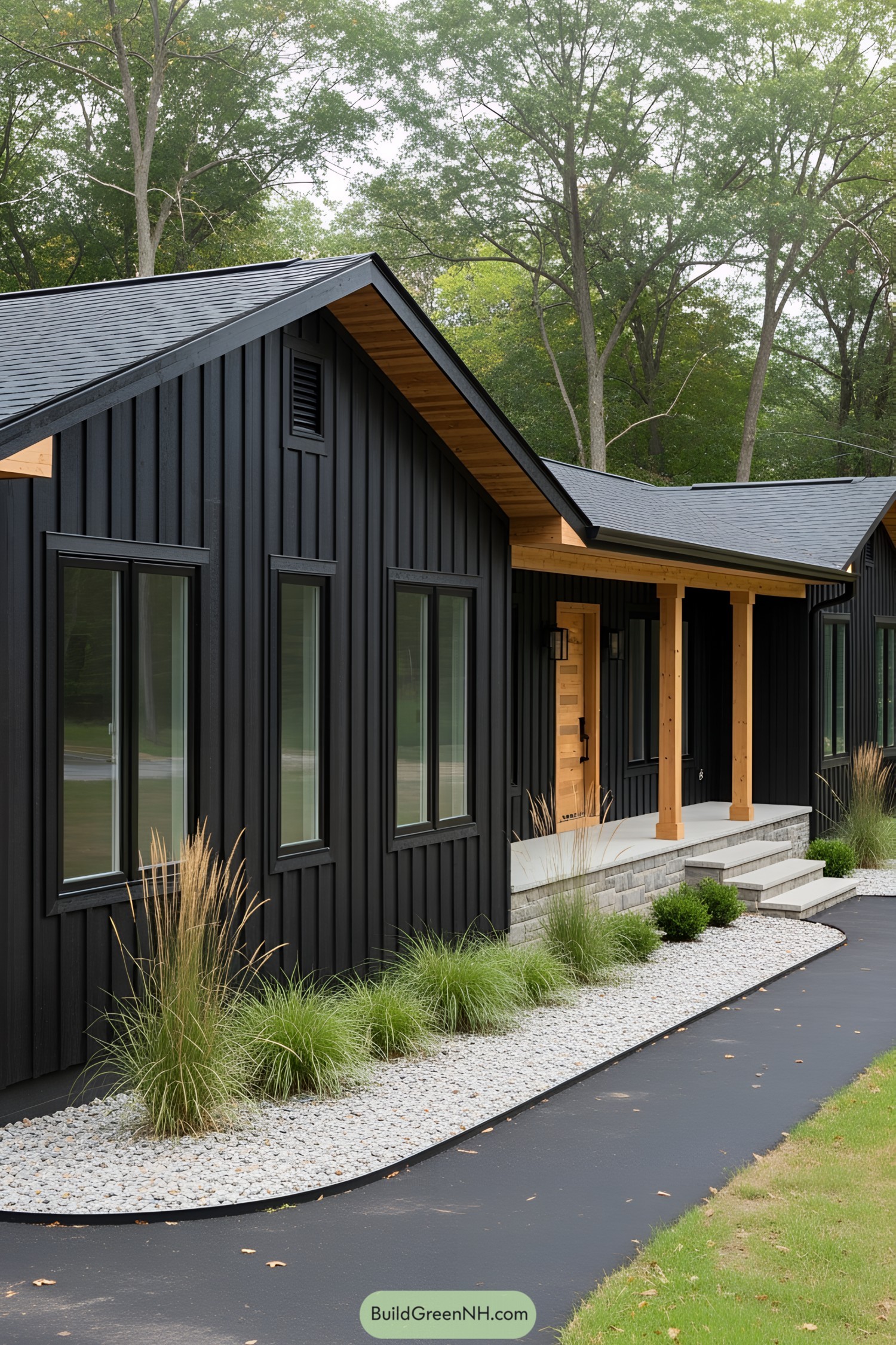 Black ranch house with wooden accents surrounded by trees