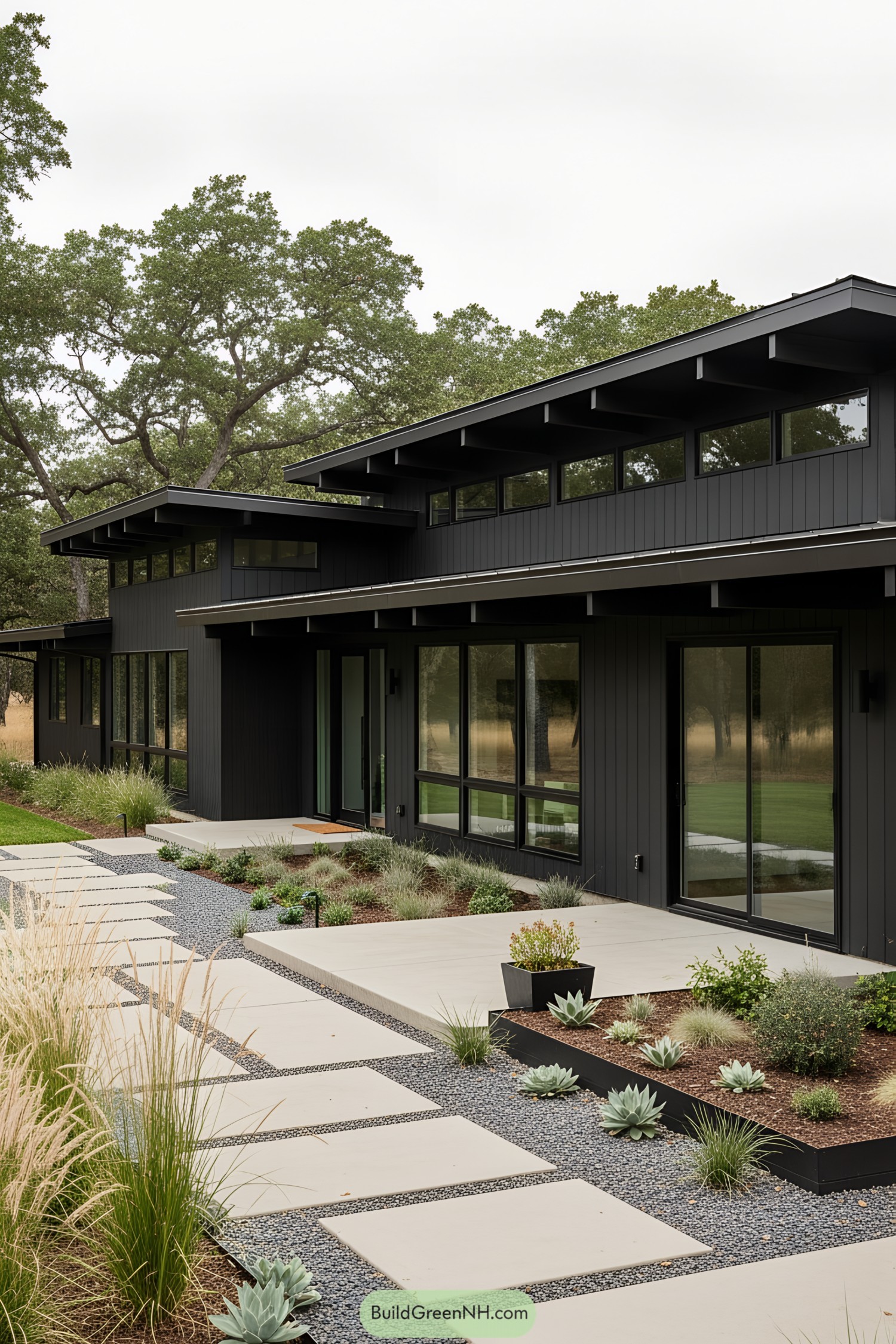 Black ranch house with large windows and modern landscaping