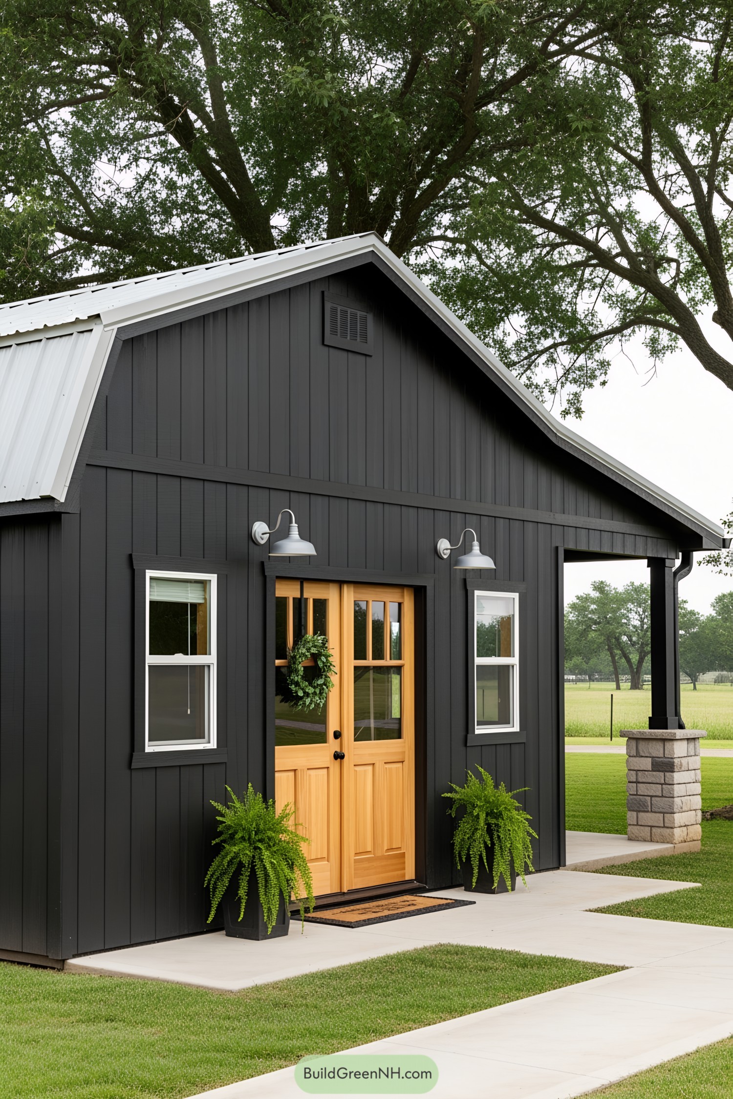 Small black shed with a wooden door and greenery