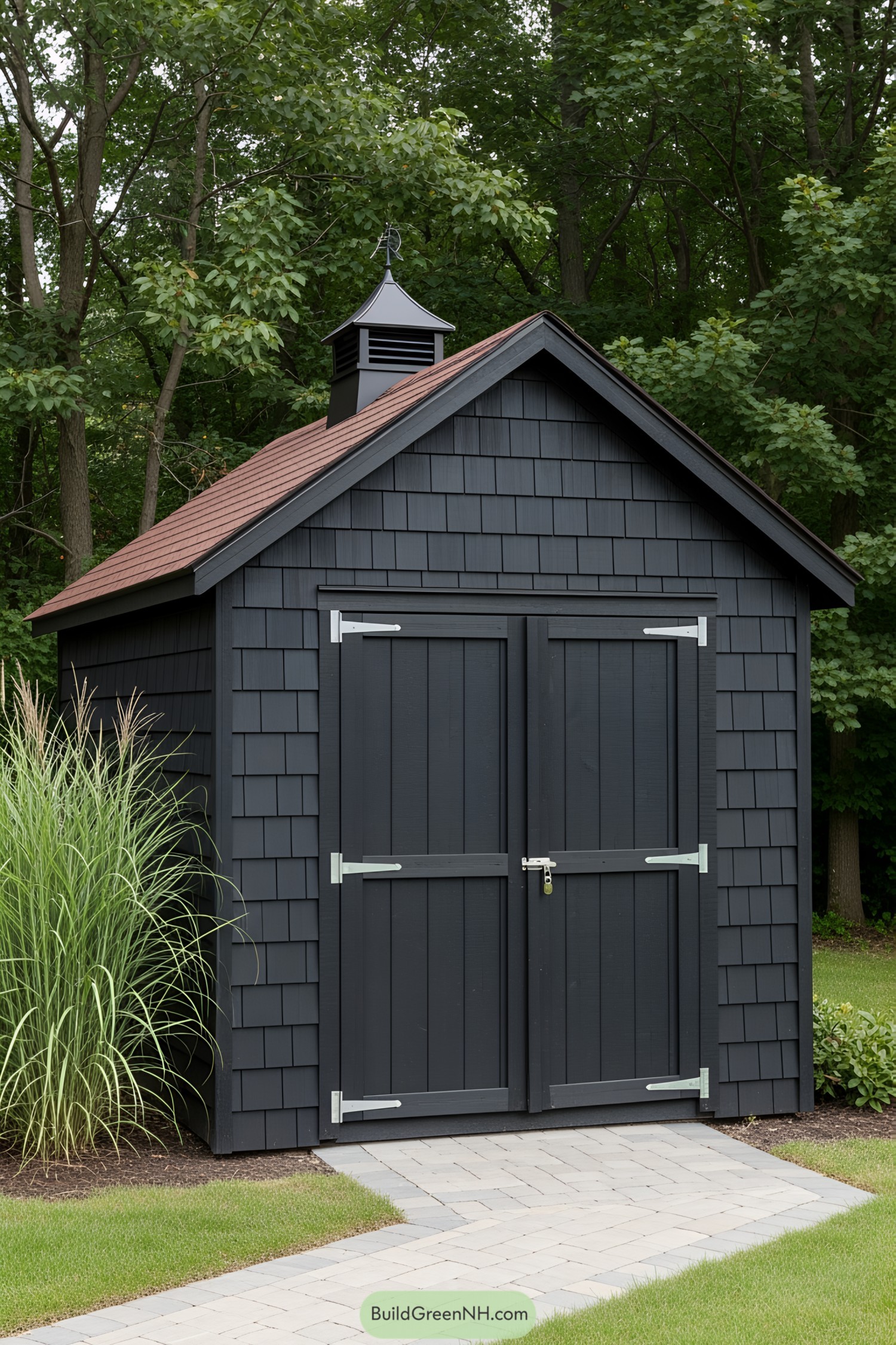 A sleek black shed with a charming roof and lush greenery