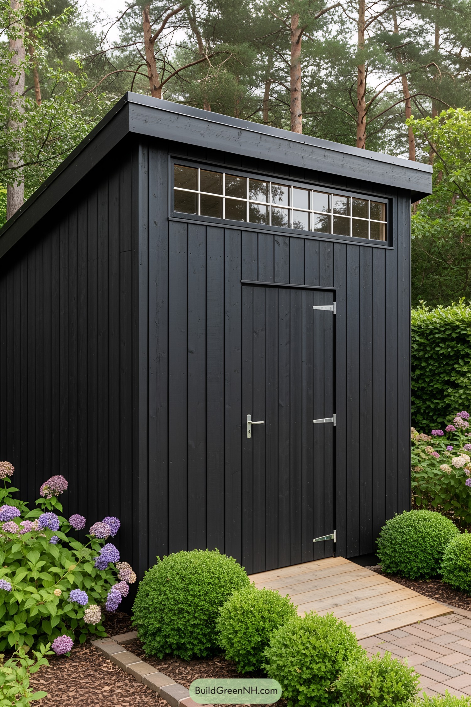 Sleek black shed with high windows in a garden