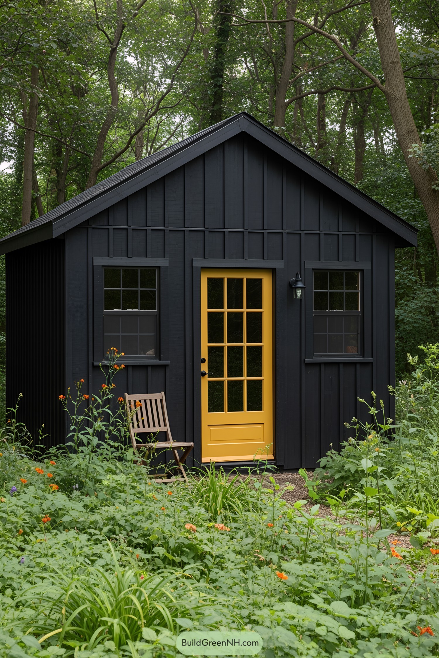 Cozy black shed with a bright yellow door surrounded by lush greenery