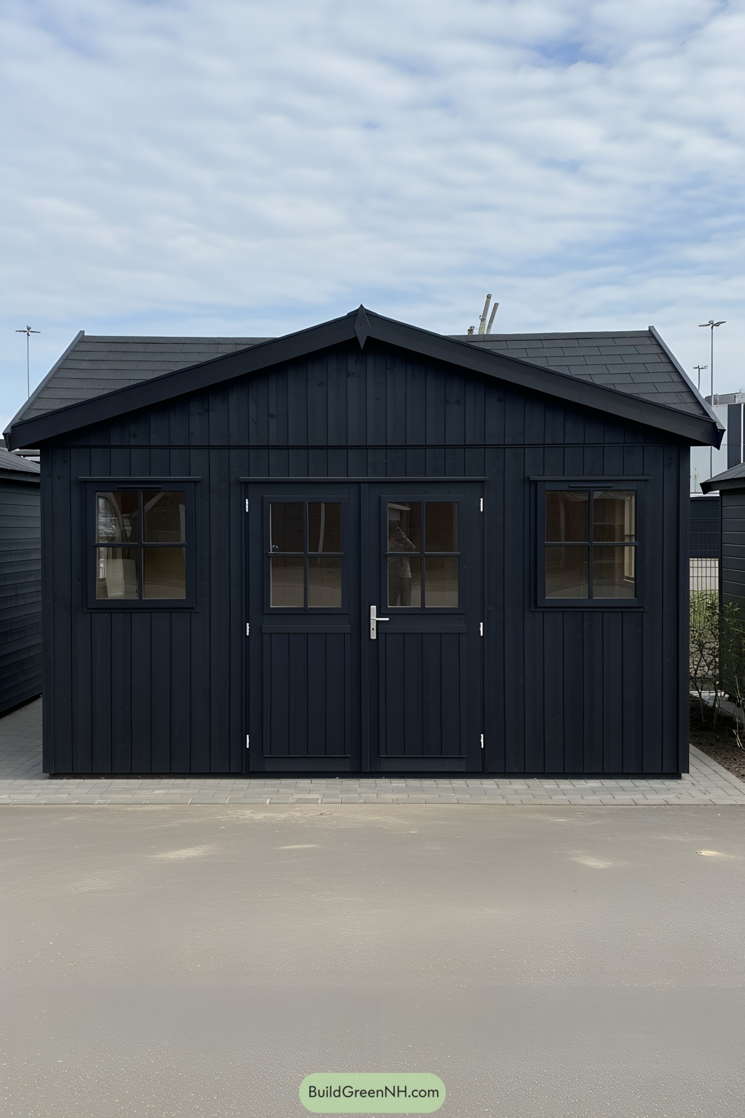 Black wooden shed with twin doors and windows