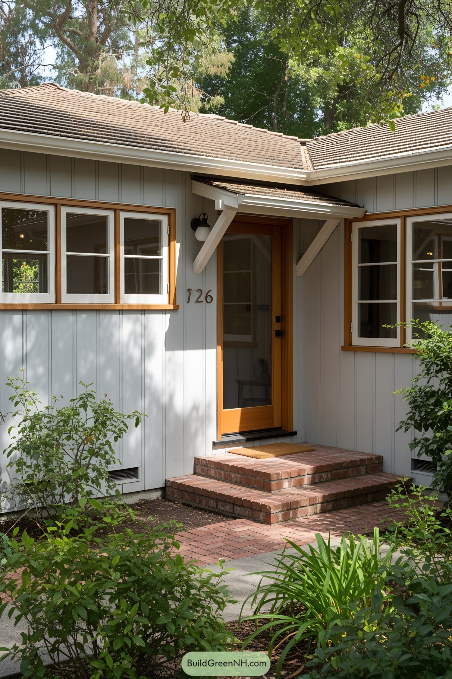 California ranch house entrance with a vibrant door and greenery