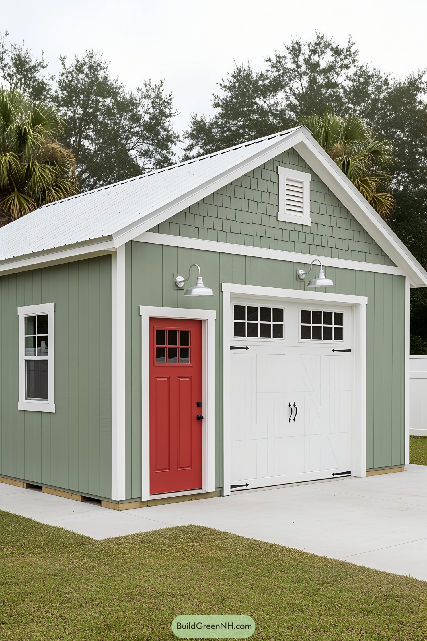 Small green car shed with a red door and white garage