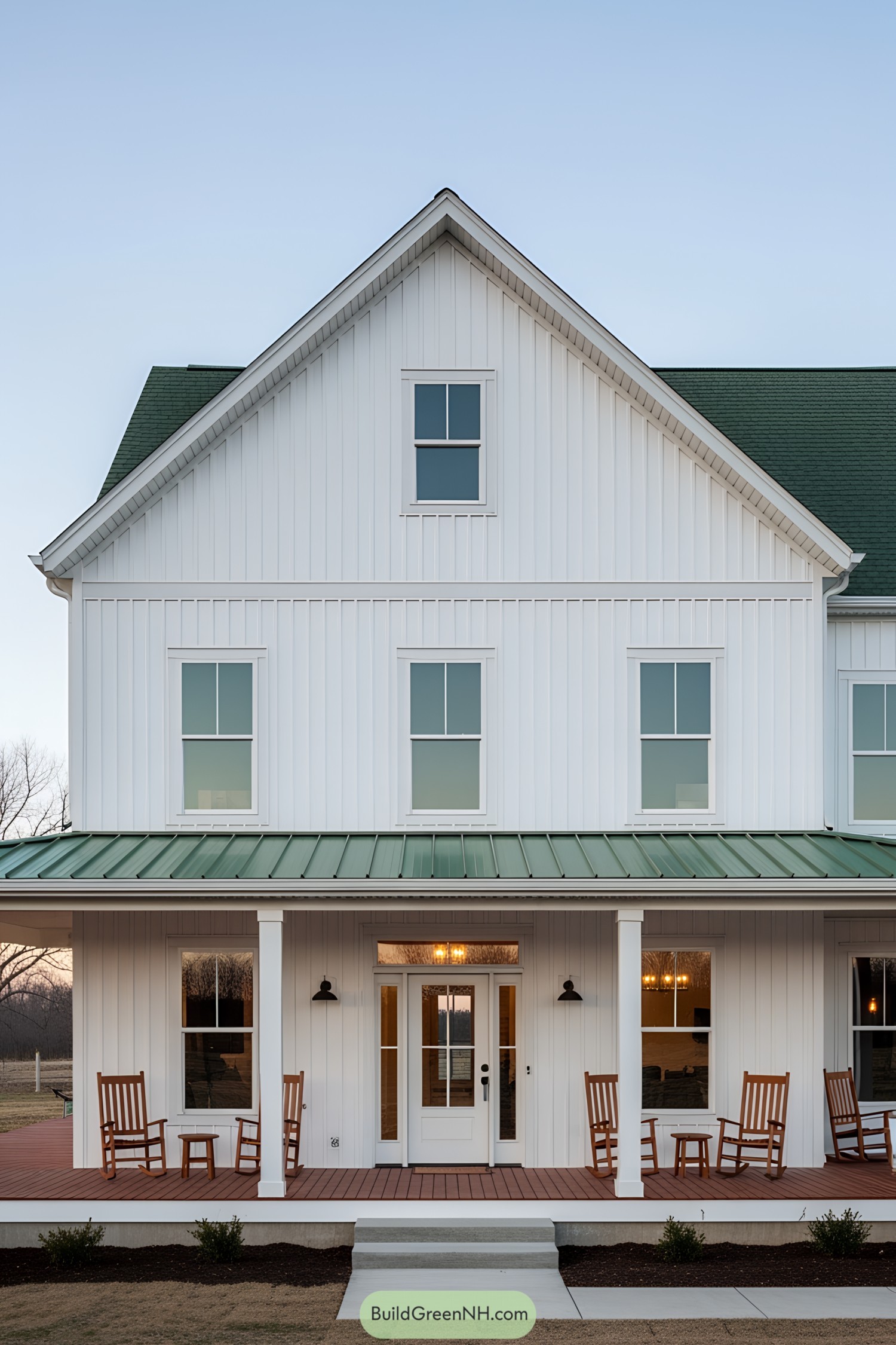White farmhouse with green roof and front porch