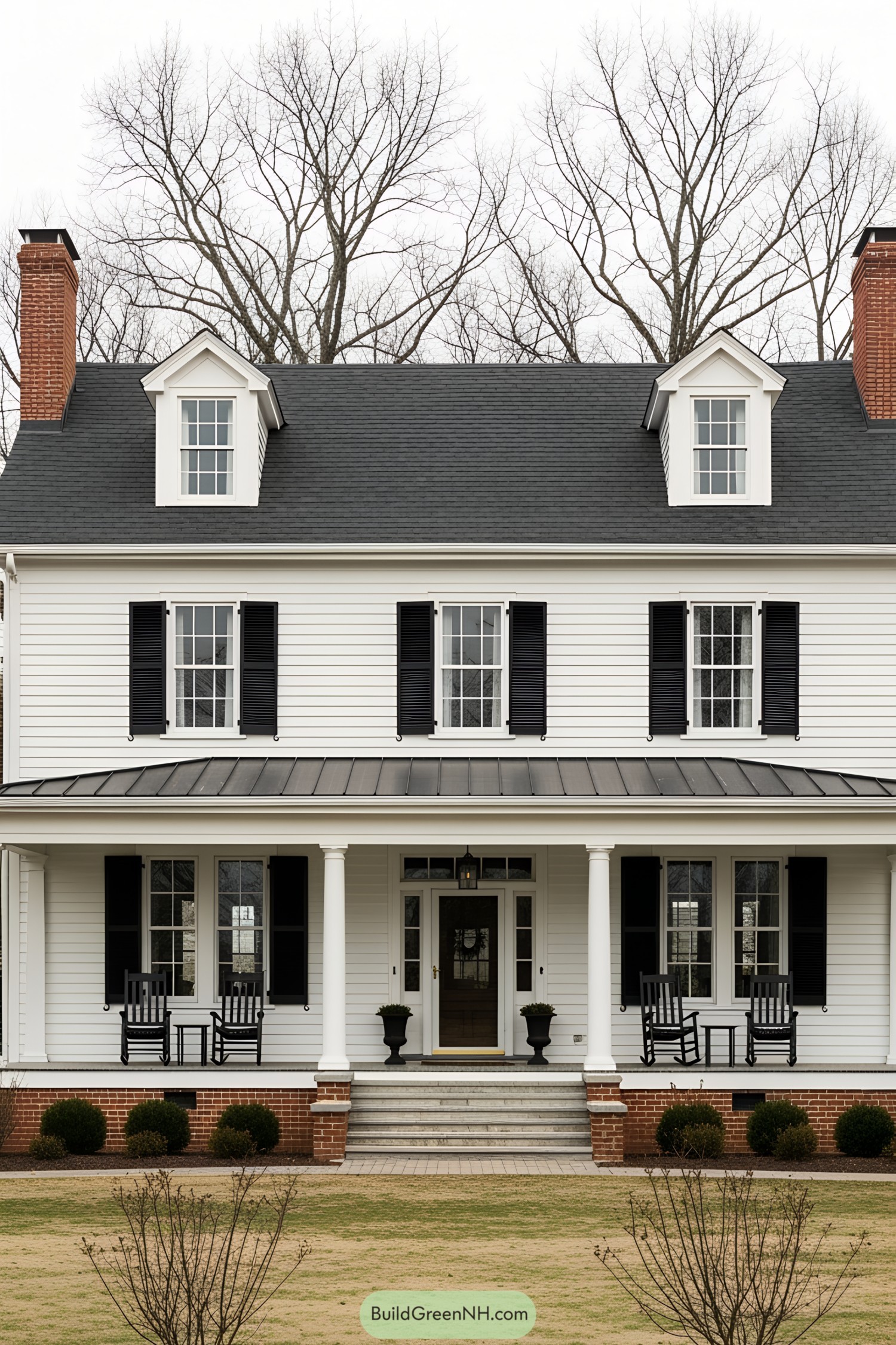 Classic white farmhouse with black shutters and a grand porch