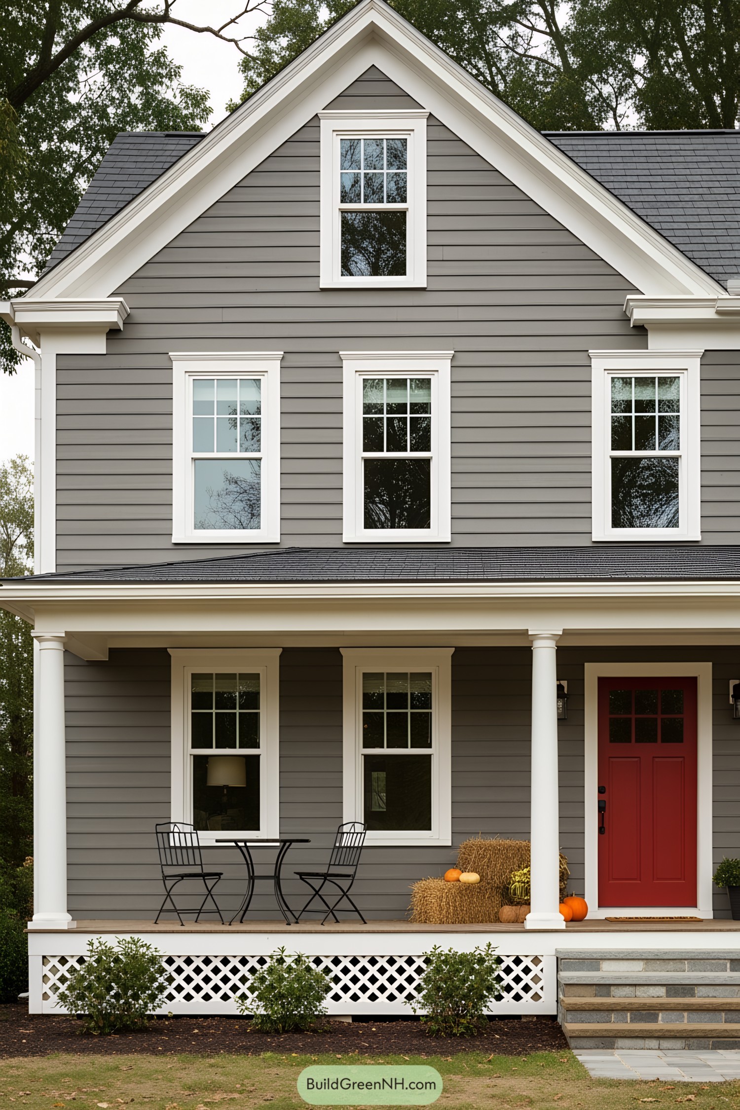 Classic farmhouse with gray siding, white trim, and a welcoming porch