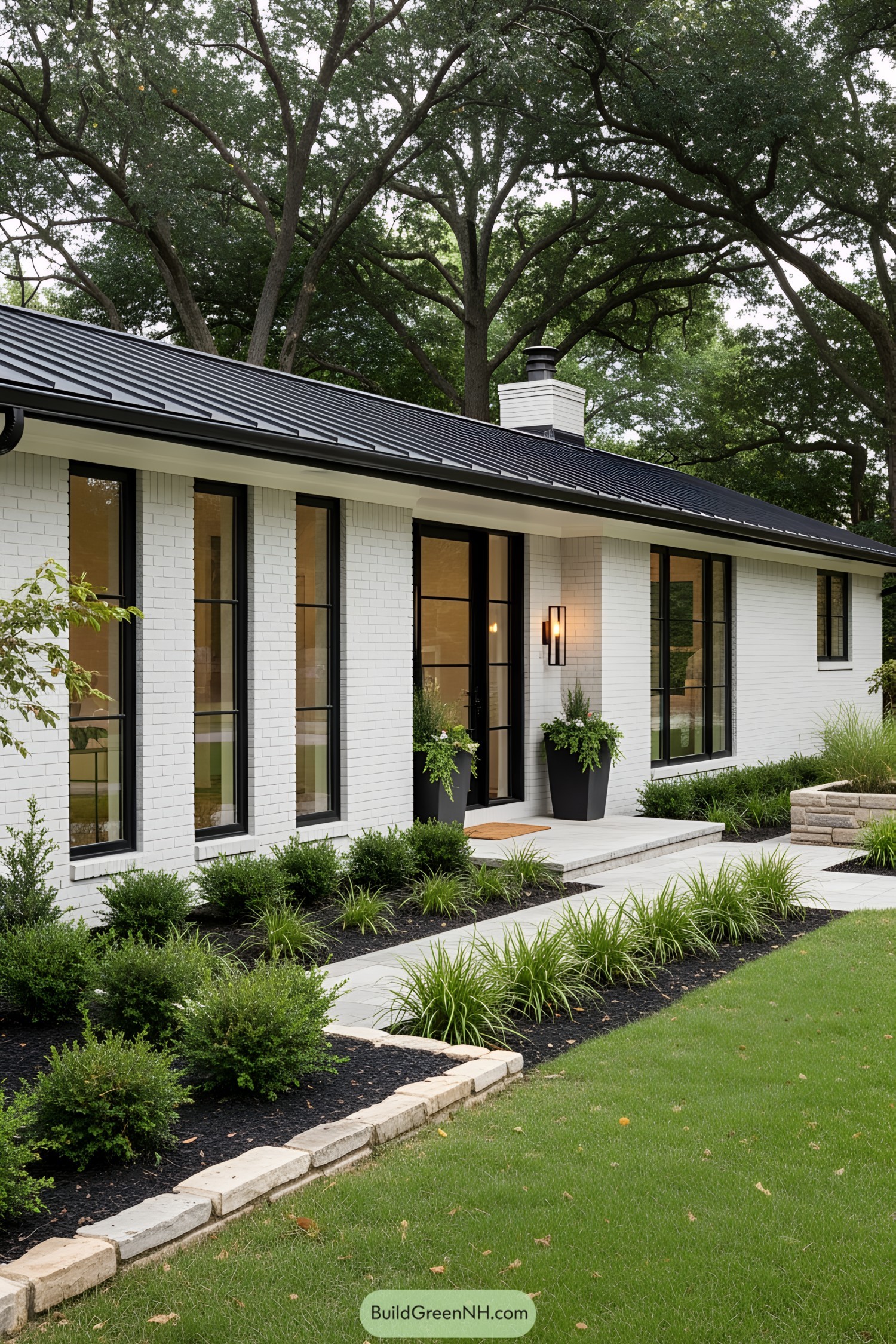 Modern ranch house with black roof and white brick exterior