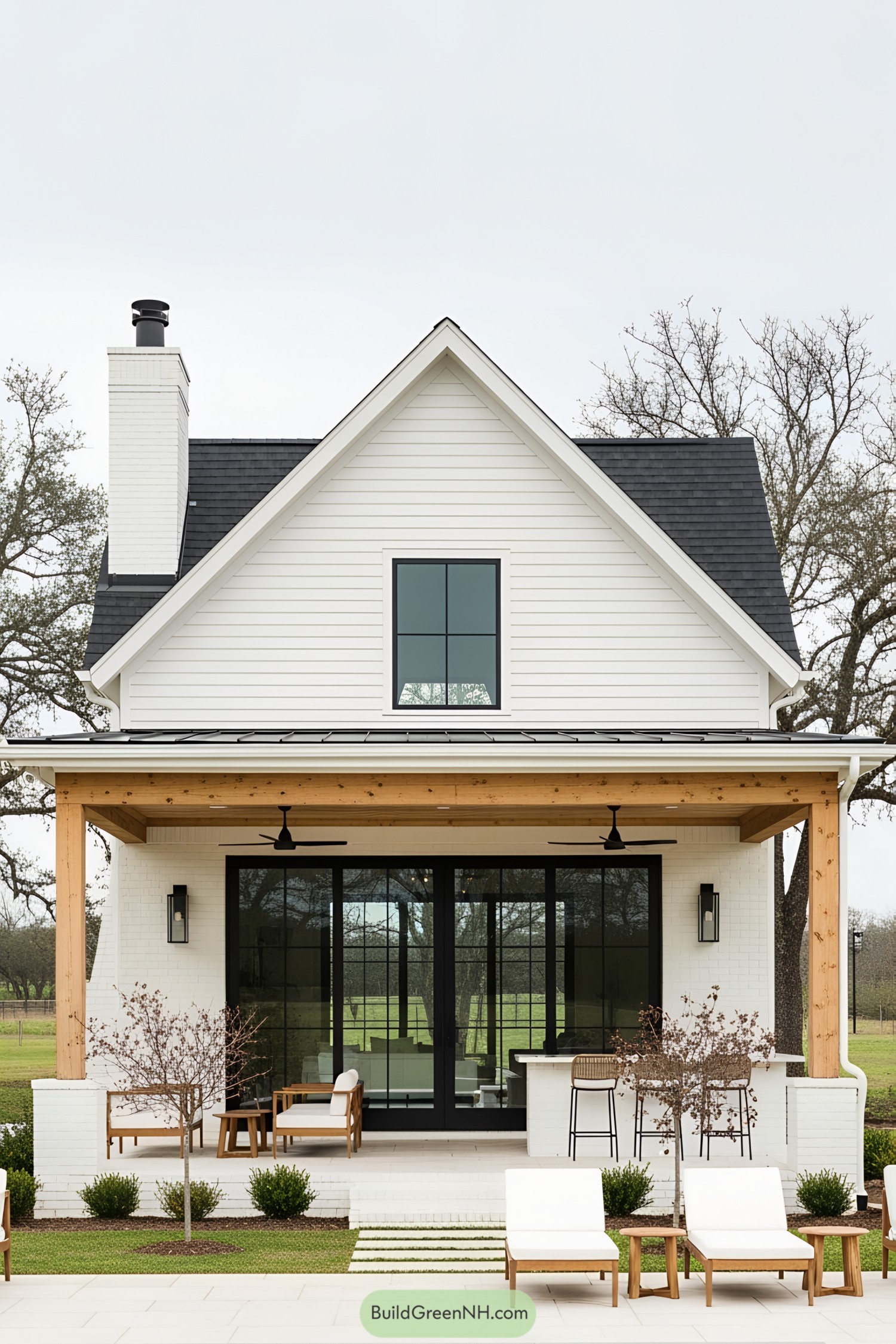 Charming farmhouse pool house with modern black accents