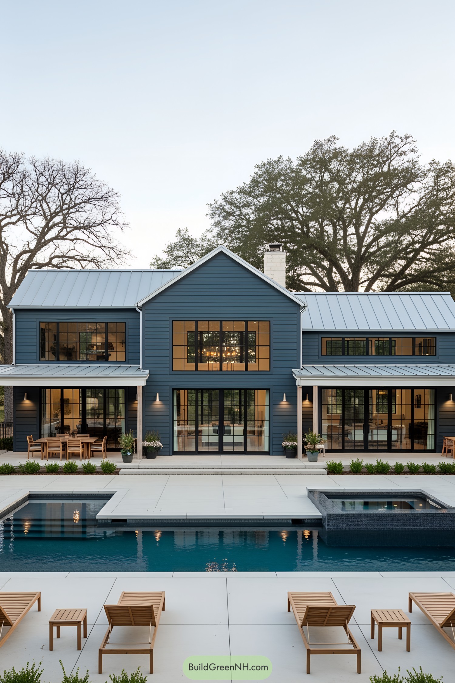 Charming farmhouse poolside view with wooden loungers