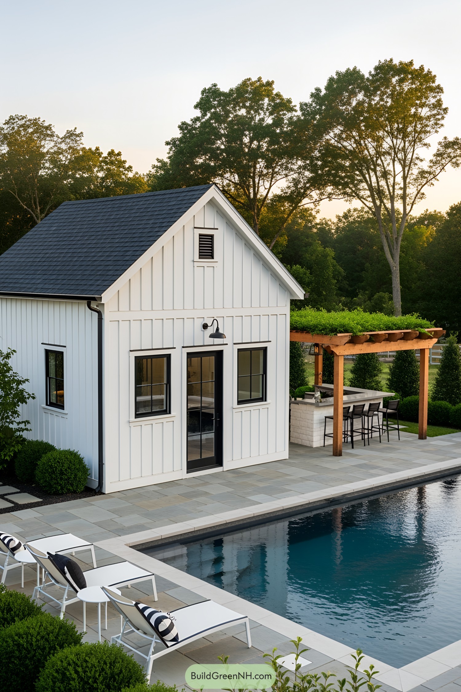 Charming farmhouse pool house beside a serene pool