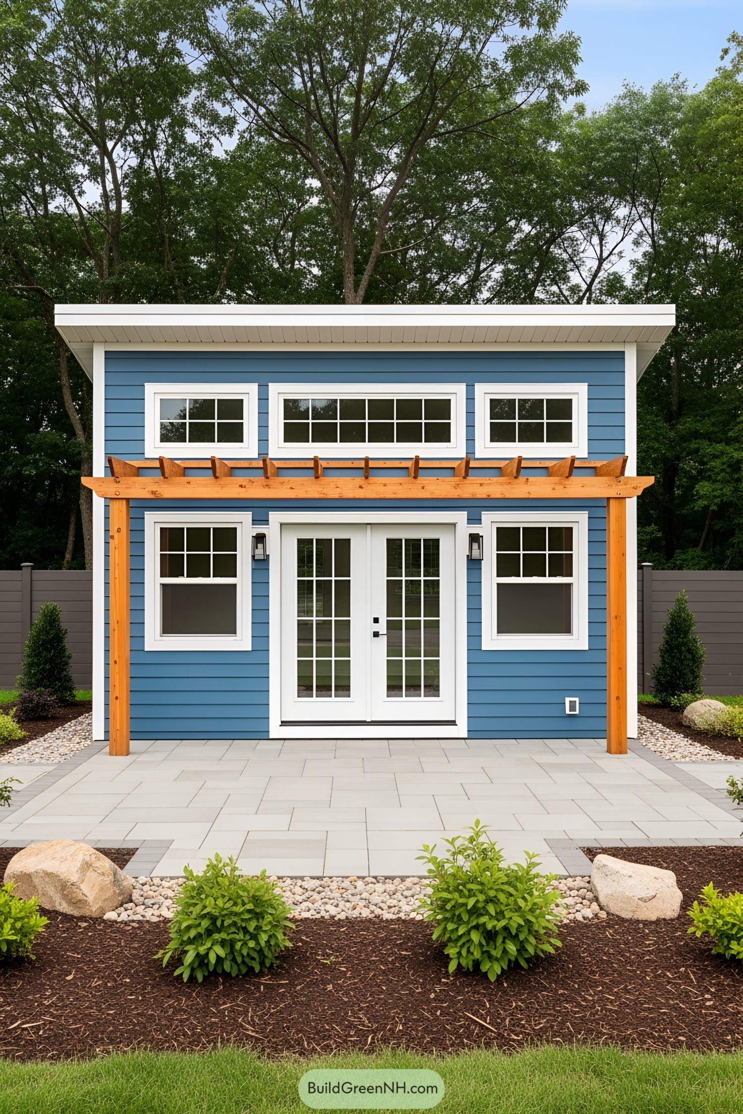 Small blue guest house with white French doors and a wooden pergola